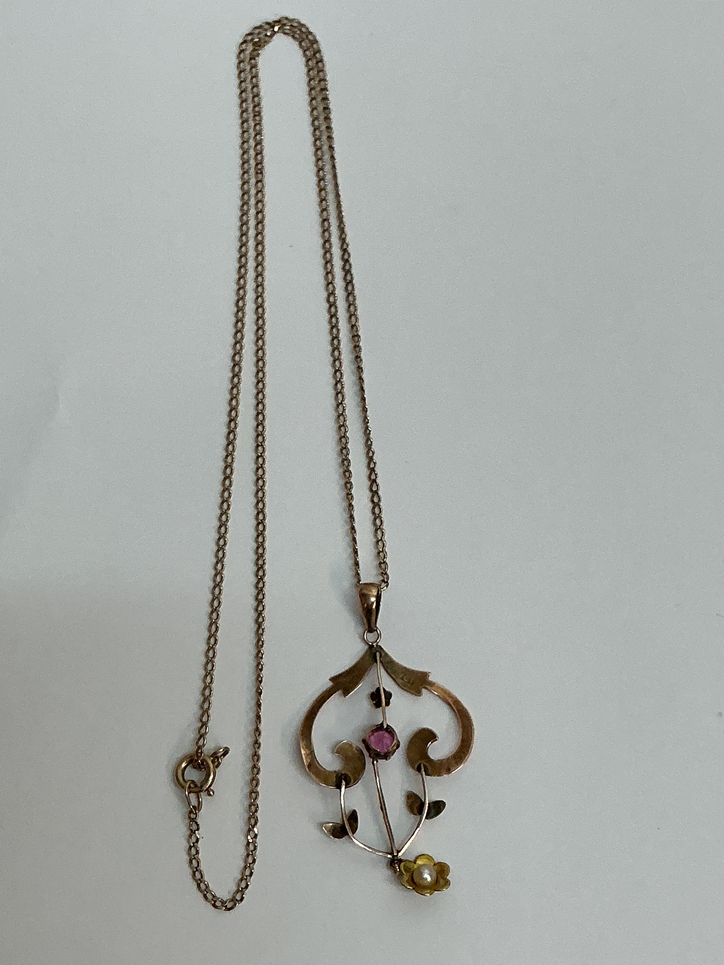 A 9ct gold Edwardian style pendant necklace set with a small pearl and pink stone.Approx L30cm 3.6g