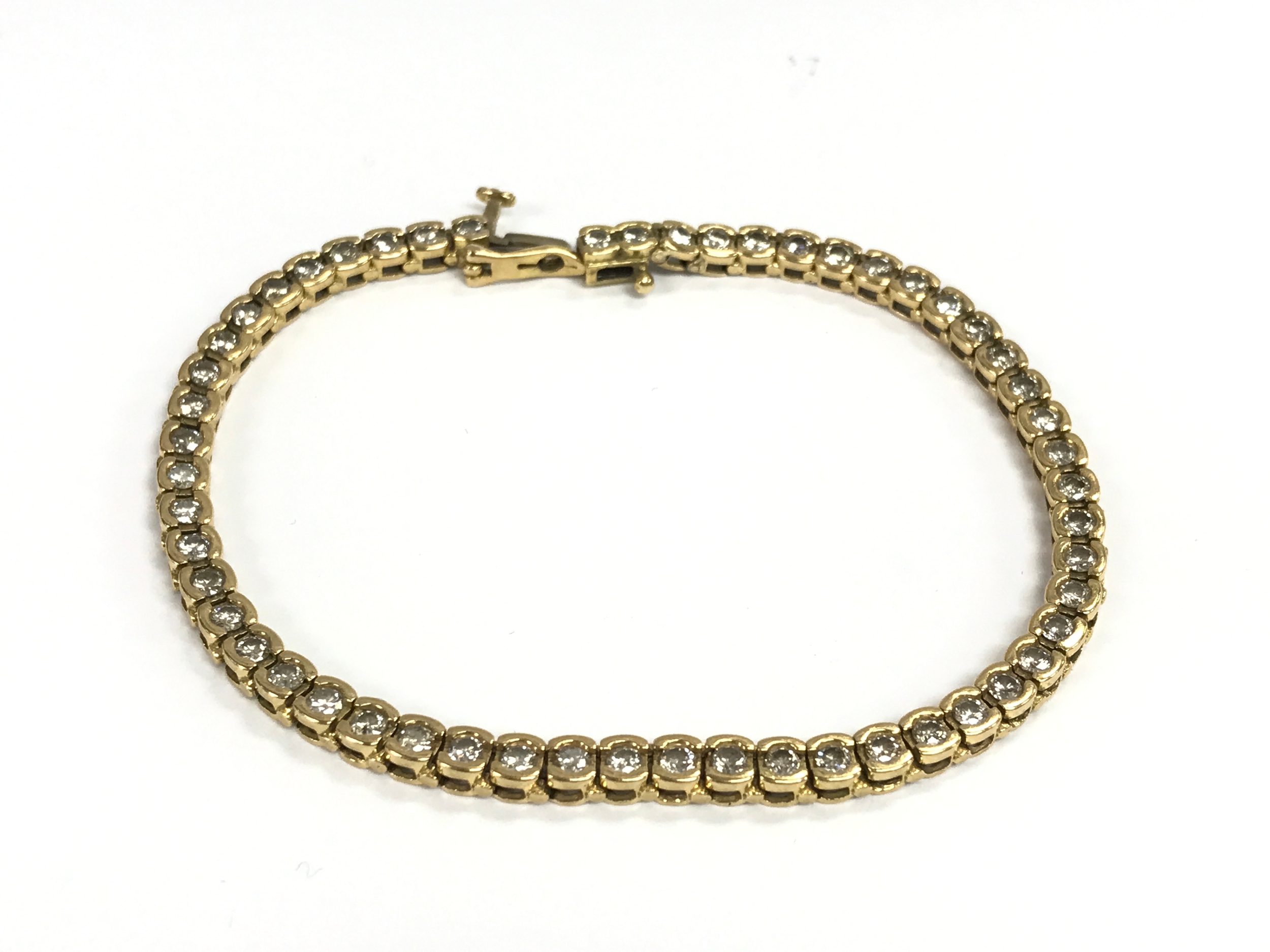 An 18ct gold diamond line bracelet. 20cm length. 15.38g