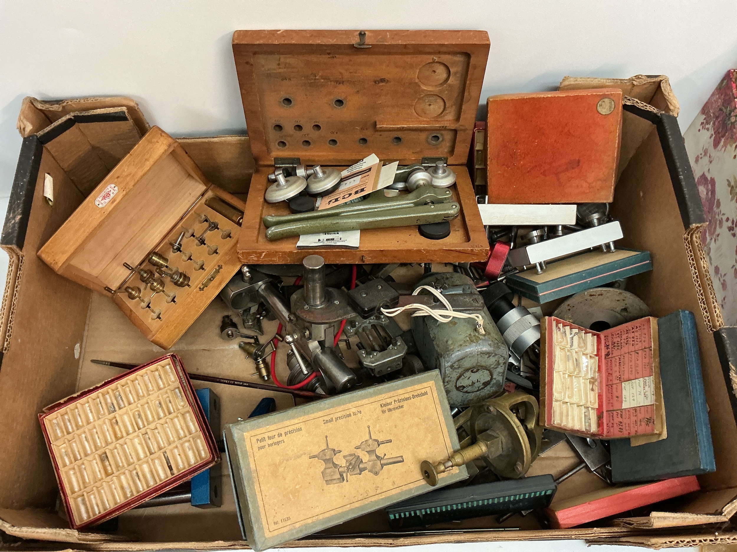 A box containing watch maker's lathes and tools, including an oak cased example, incomplete.