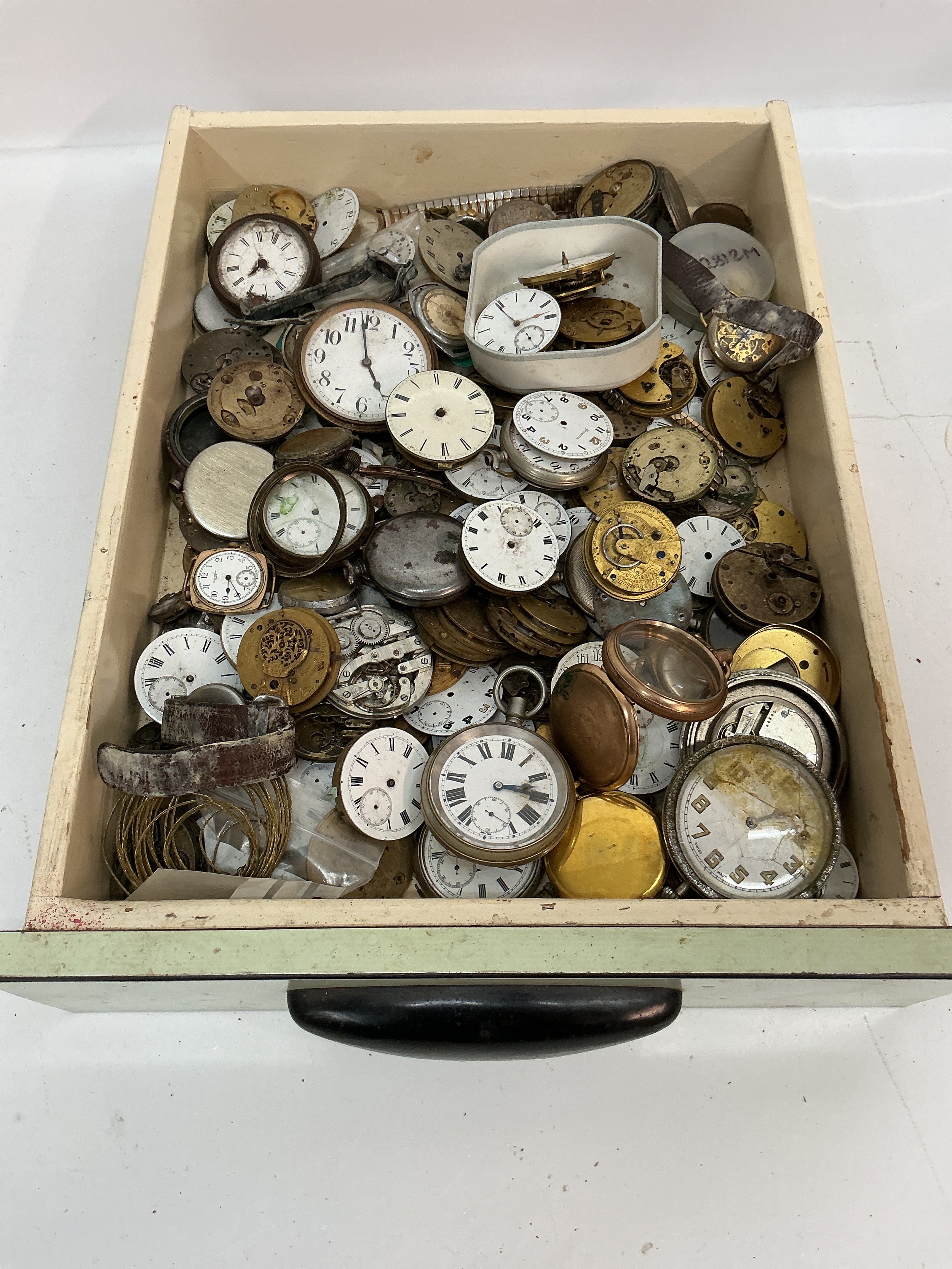 A tray containing assorted antique watch movements including yellow metal pocket watch case. Offered as spares or repairs 