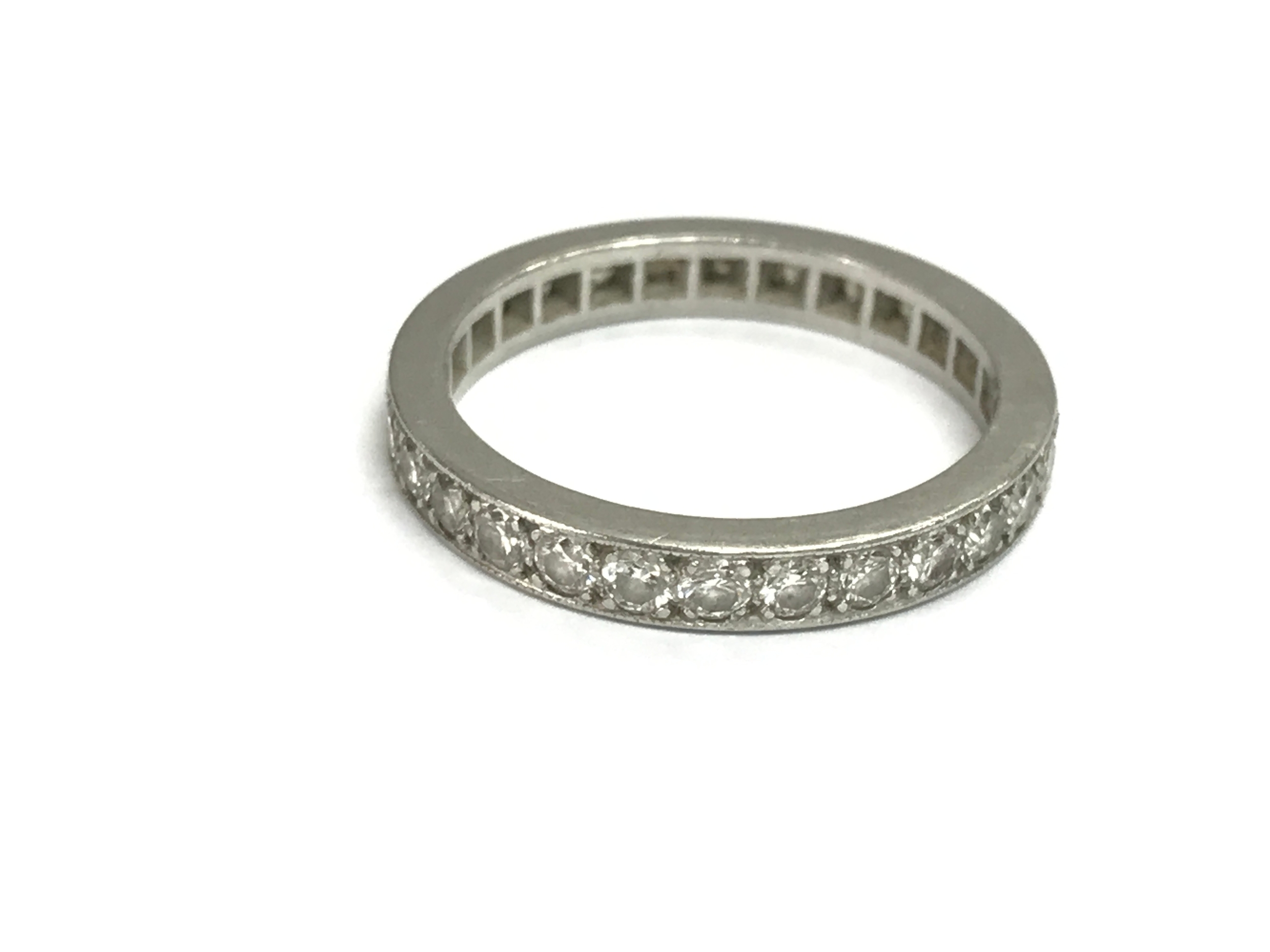 An unmarked white gold eternity ring. Size P 1/2 and 4.82g