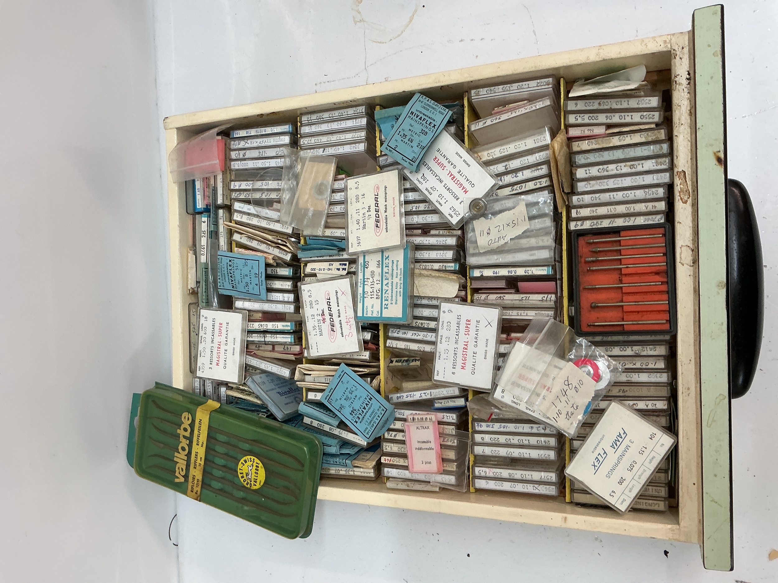 A tray containing boxed watch springs