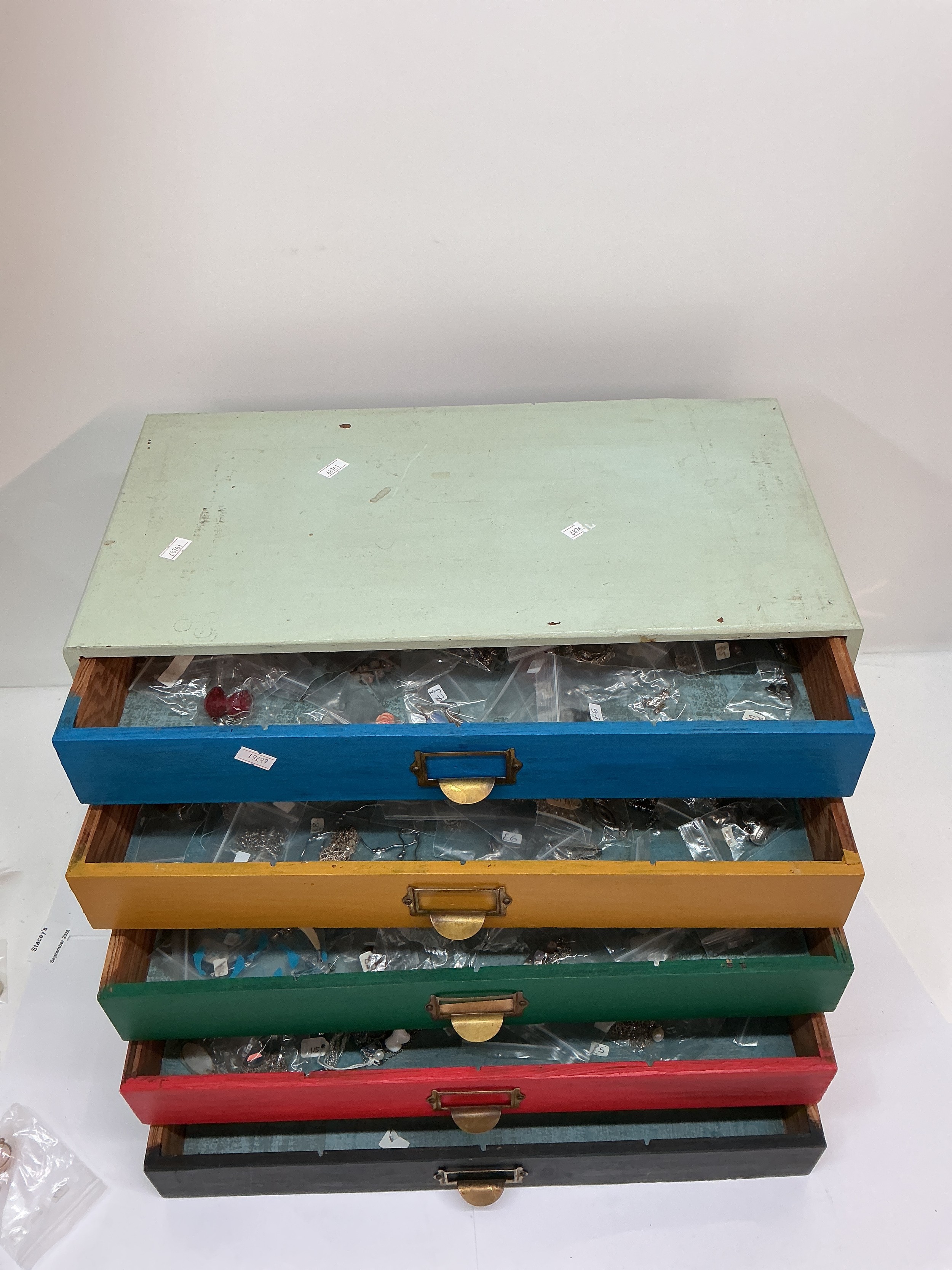 A wooden drawer unit containing modern white metal 925 dress jewellery. Approx 25 x 47cm.