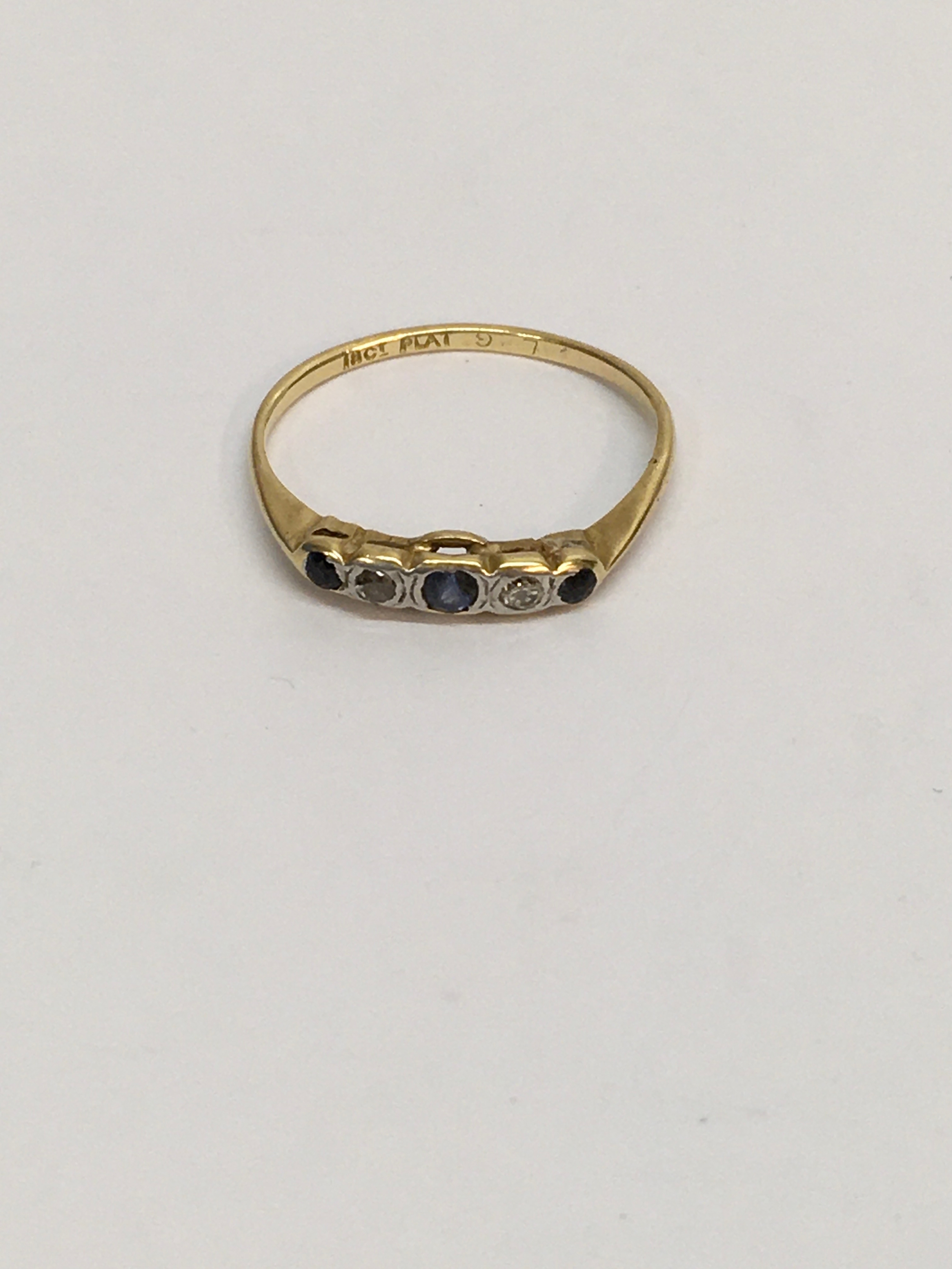 An 18ct gold plat. ring set with band of small blue and white stone stones. Approx size P, 1.81g