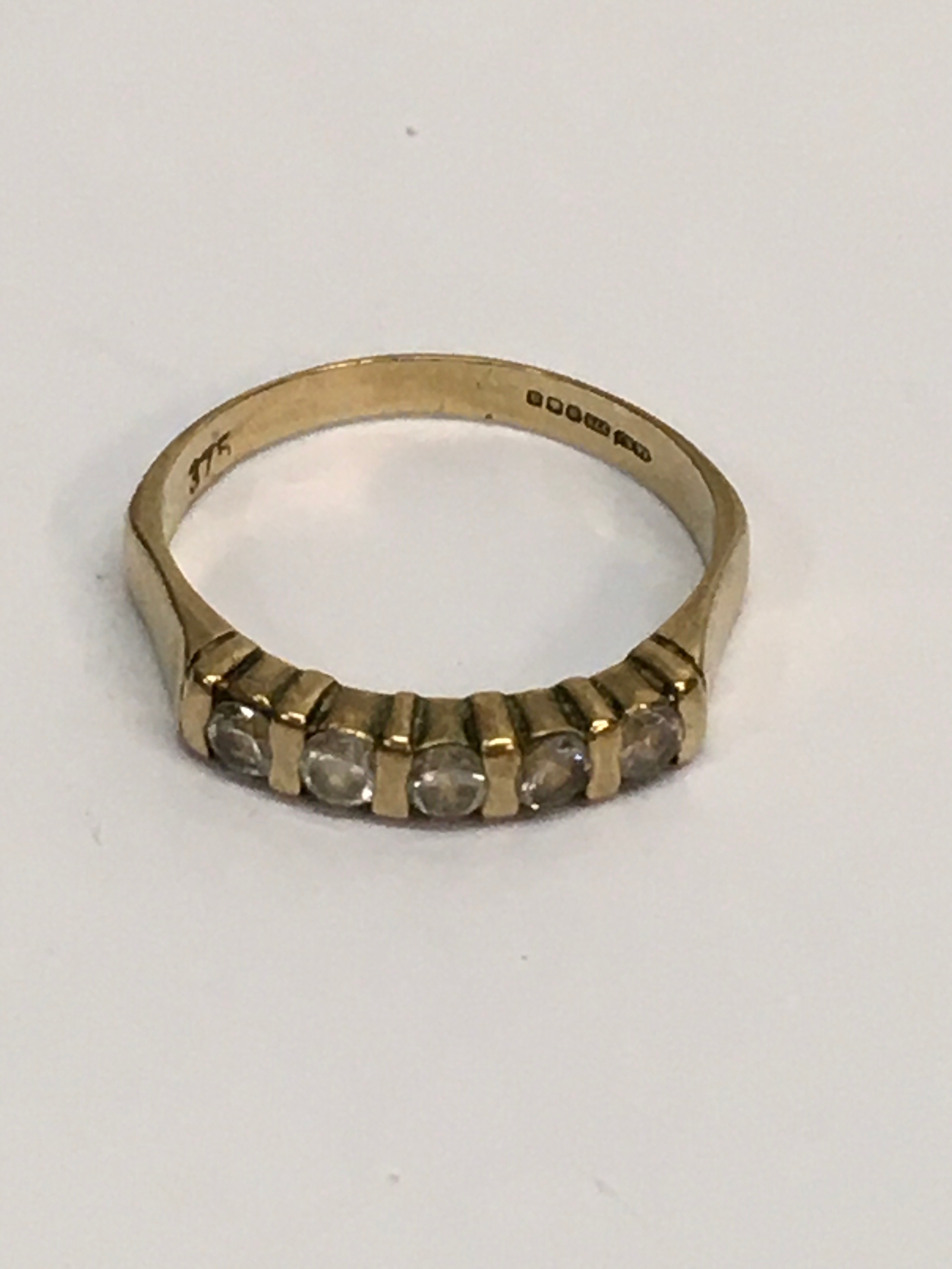 A 9ct 375 gold ring set with band of white stones.Approx P/Q, 2.19g