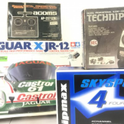 A Boxed Tamiya 1/10th Scale Radio Controlled Jaguar X JR-12 Racing Car Model Kit With 3 Boxed Controllers.(4).