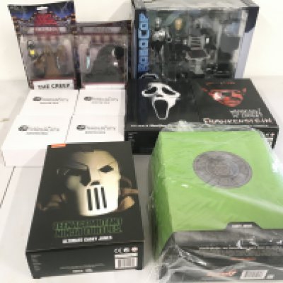 A collection of Neca and Super 7 figures with accessories.