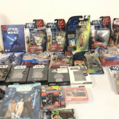 A Box Containing Various Carded Star Wars Figures. Collectors Imgots. DVDs. And Books. No Reserve.