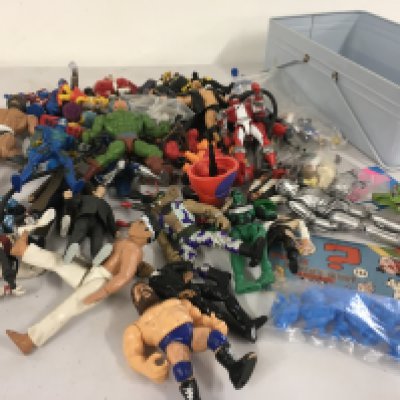 A box containing a mixture of action figures by various manufacturers and characters including Batman..Dr Who..Karate kid..HeMan..WWF..Simpson etc.  no reserve 