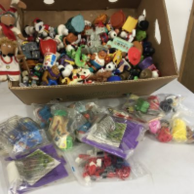 A box containing a large number of figures depicting many characters including Snoopy..Wombles..etc.  includes toys issued with McDonalds food some unopened.  No reserve 