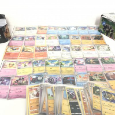 A Collection Of Pokemon Cards in Two Tins. Approximately 500 In Protective Sleeves. No Reserve. 