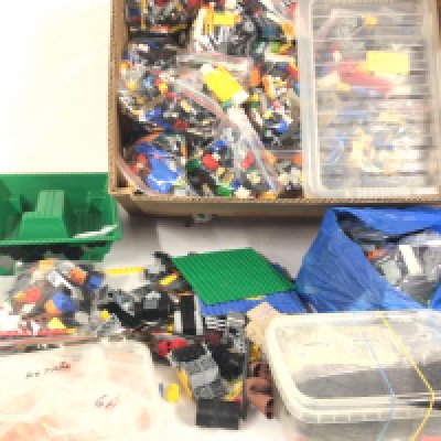 A box containing a large variety of Lego pieces.  No treserve