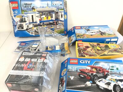 A collection of opened lego sets including city Lego.