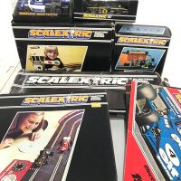 2 Boxed Scalextric Cars. A Ford Escort Mexico #C.052. A March Ford 240. A Auto Start. Pitstop. Lap counter. Hump Bridge. And Catalogues. And Track.