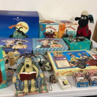 A varied collection of Wallace and Gromit merchandise including, saving bank, display figures, cuff links, stationery sets  etc.  no reserve