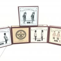 A Collection Of Boxed Britains Figures Including Scots Guards Drummer #40211. Boy Scouts Of America #5971. Scots Guards Pipers #40210. Scots Guards 1899 Present Arms #00256  And Chelsea Pensioners.(5).