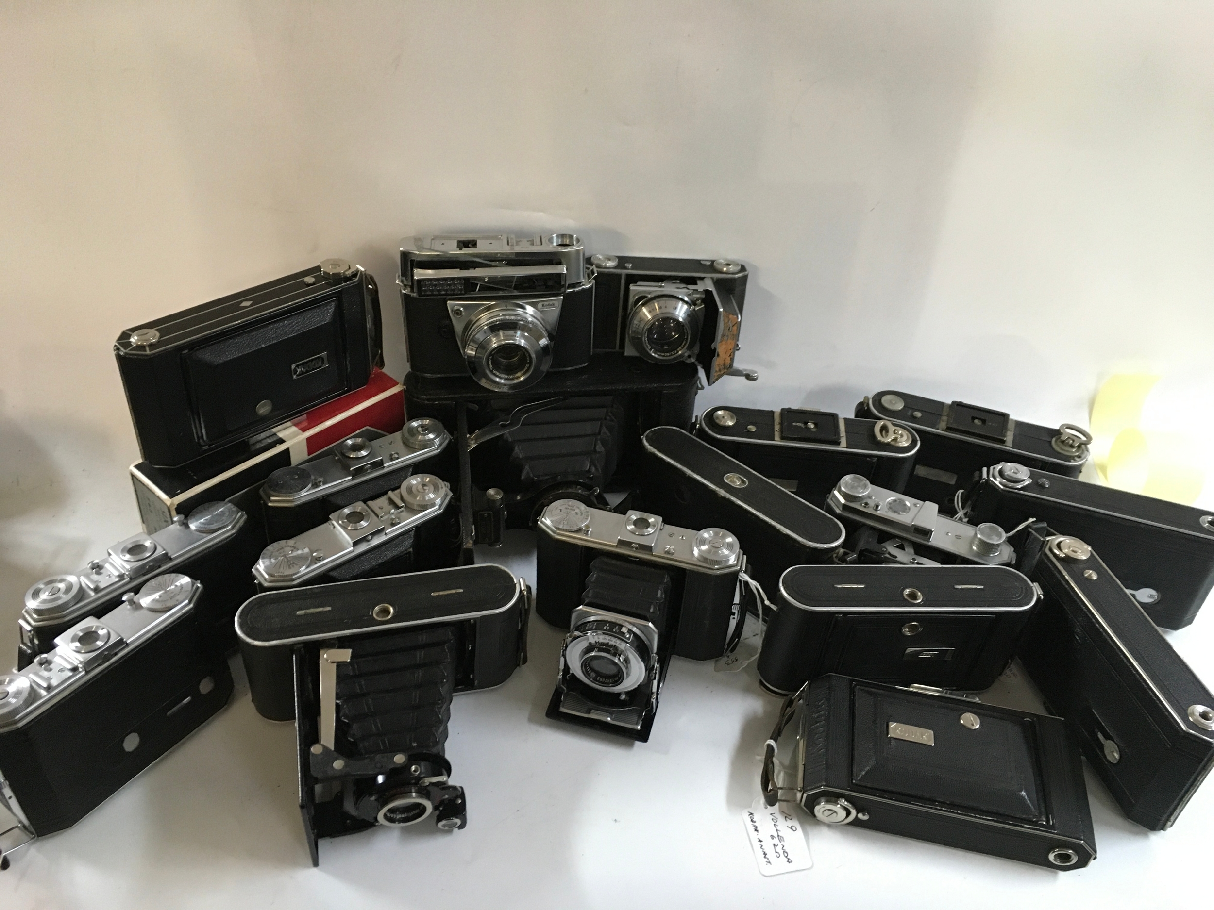 A large collection of cameras featuring brands like Kodak and Nagel. 