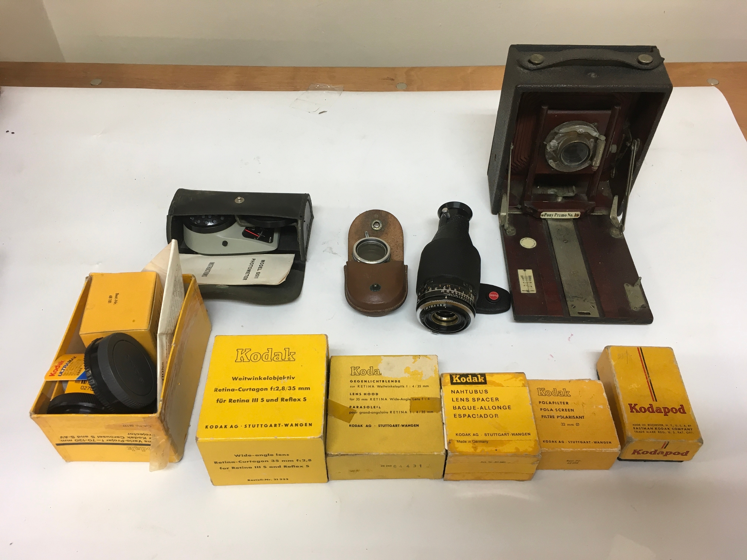 1 GEM Pony Premo No.1. Kodak detachable camera lens. Model S511 Photometer with instructions. Assortment of Kodak accessories; pola filter/ screen, kodapod, lens spacer, lens hood, wide angle- lens lens variations, and a Kodak series V adapter ring with pouch.