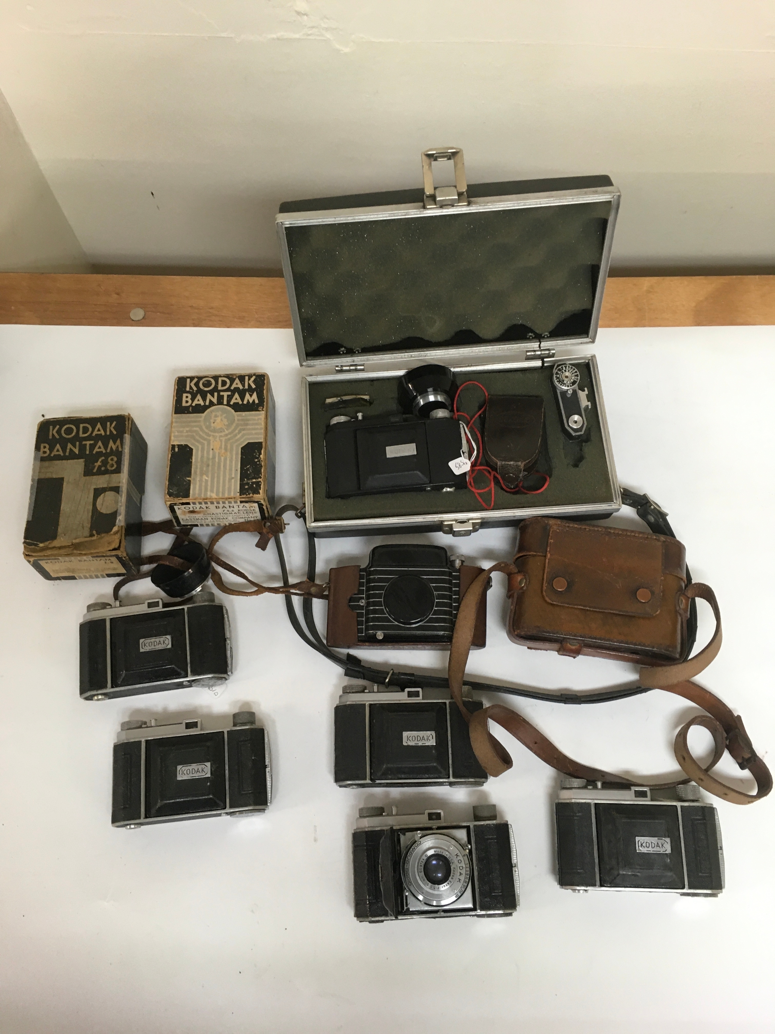 10  Kodak Compur rapid / Bantam special cameras. Two including carrier pouches and Compur rapid case with lens accessories , range finder and lenses. 2 Kodak bantam boxes are also included.