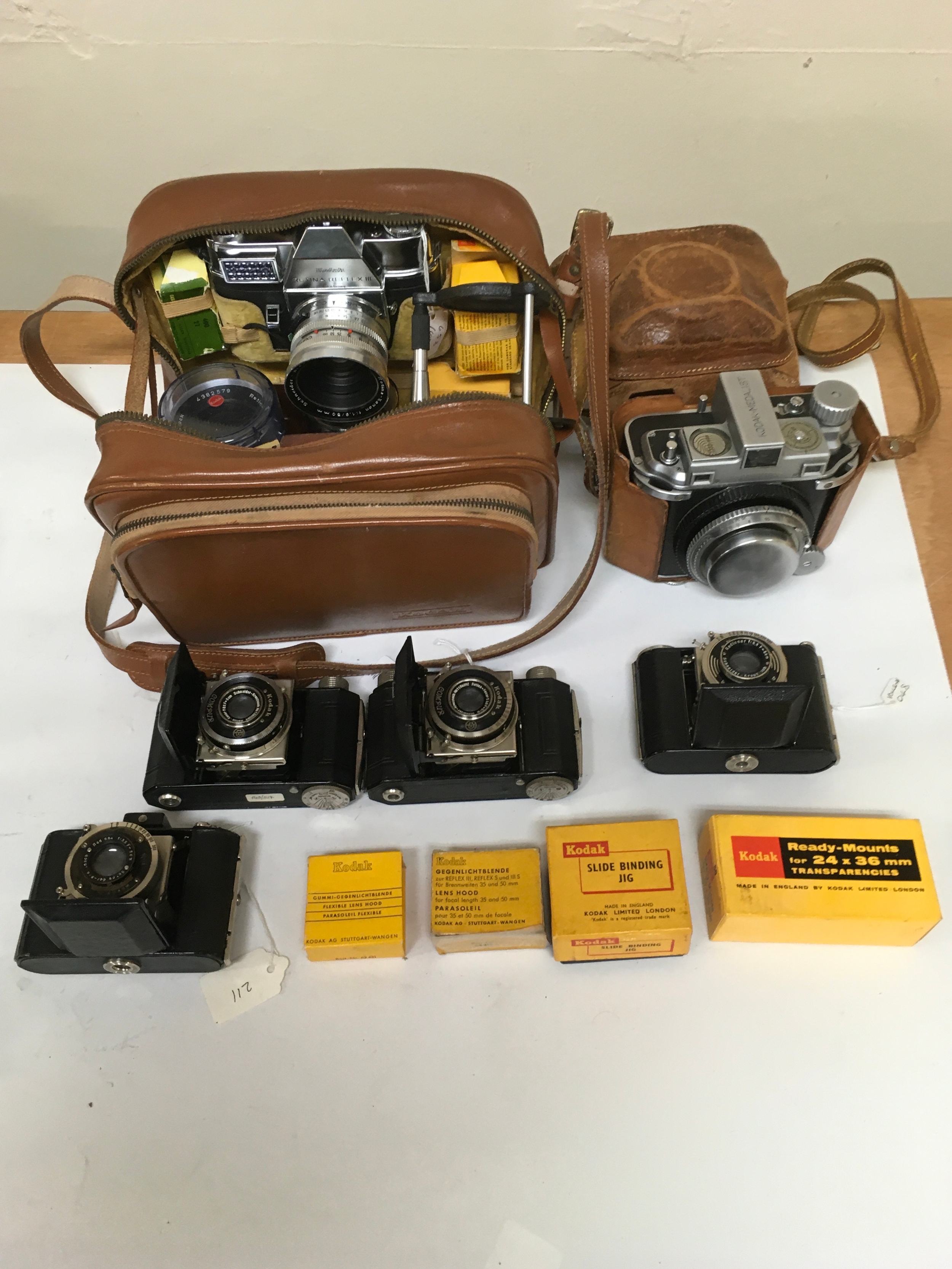 X6 Cameras. Kodak Retina Reflex III with carrier and assortment of lenses manual and viewing accessories. Kodak Medalist with holster/ carrier. X3 Kodak compur/ Rapid/Nagel. X2 lens hood with box. Slide binding jig. Ready -Mounts.