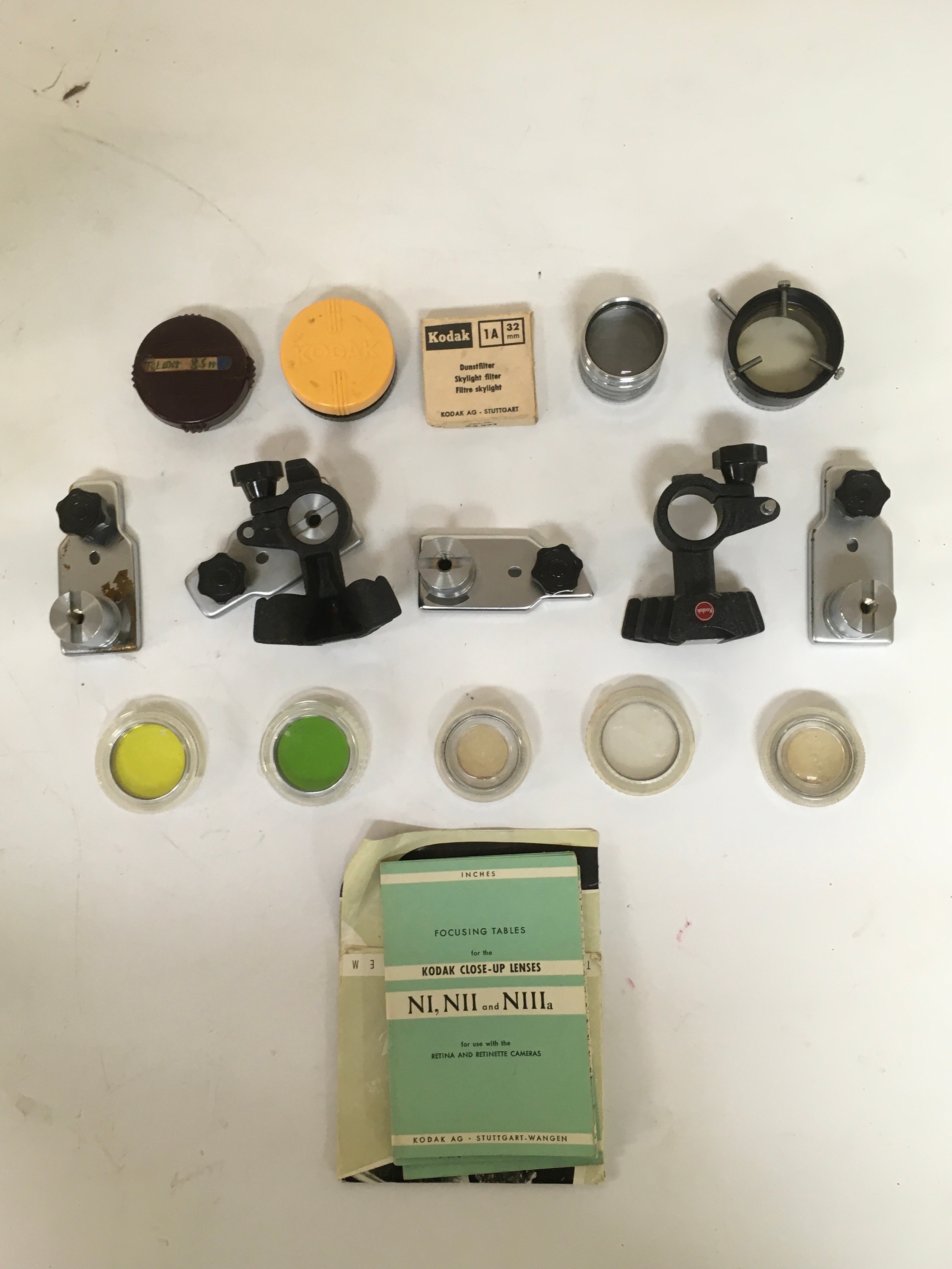 Array of camera parts Kodak  lenses with focusing tables for Kodak retina cameras. 4  camera mount parts.
