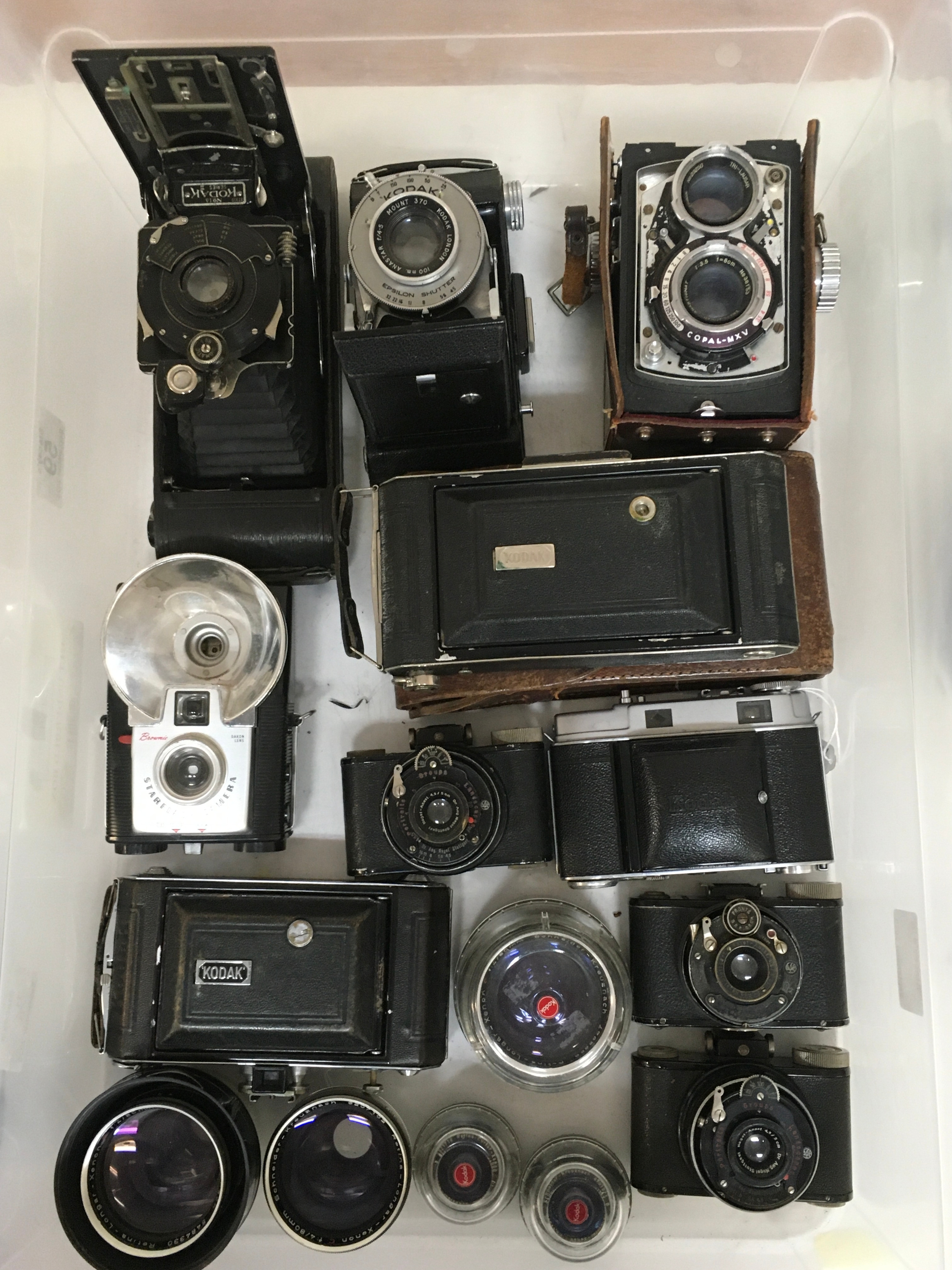 15 items. An assortment of cameras and lenses. Several Nagel Ranca cameras. Kodak II C. Kodak Vollenda 620. Kodak Junior 616 with holster/ carrier. Kodak series III. Kodak Epsilon shutter, Copal- MXV. Brownie Starflash Camera. assortment of 5 camera lenses.