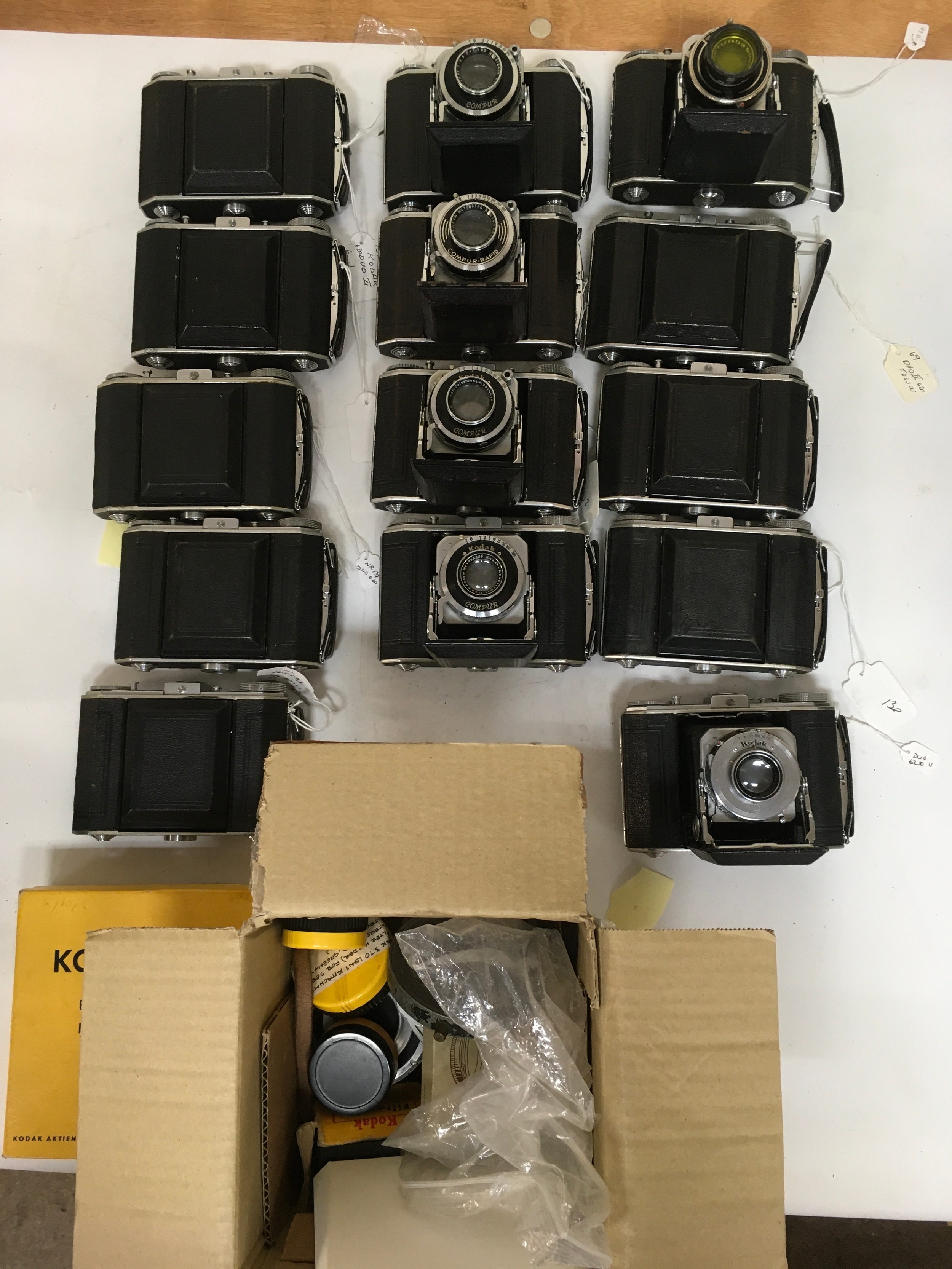 15 items. 14 Kodak Duo 620. One includes lens filter and hood. 1 box of Kodak  camera accessories.