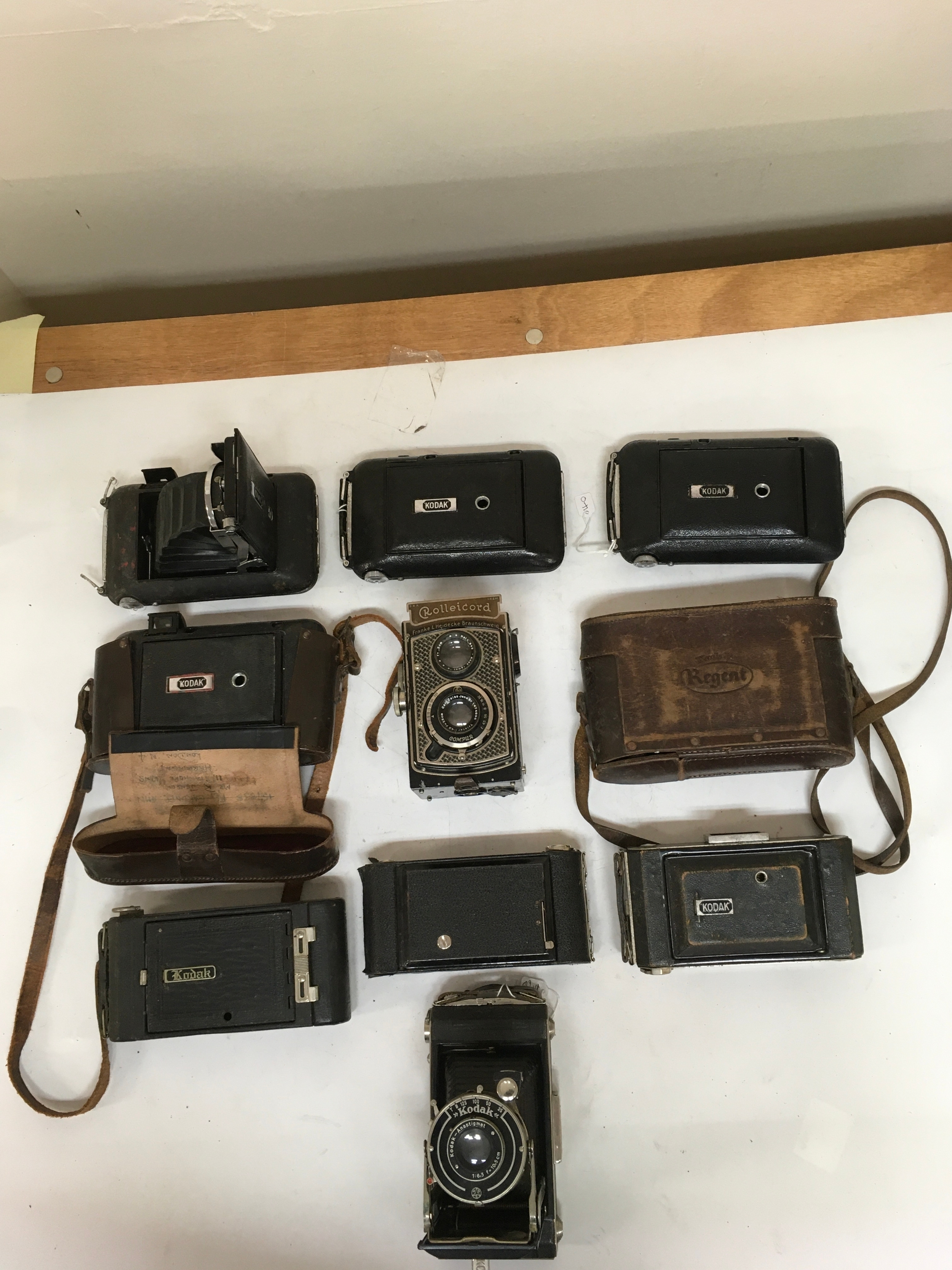 10 camera items including 5 Kodak Regent cameras and 2 Kodak regent holsters. 1,  Rolleicord  Franke & Heidecke Braunschweig Compur. 2 Kodak- Anastigmat. 2 Kodak automatic film cameras.
