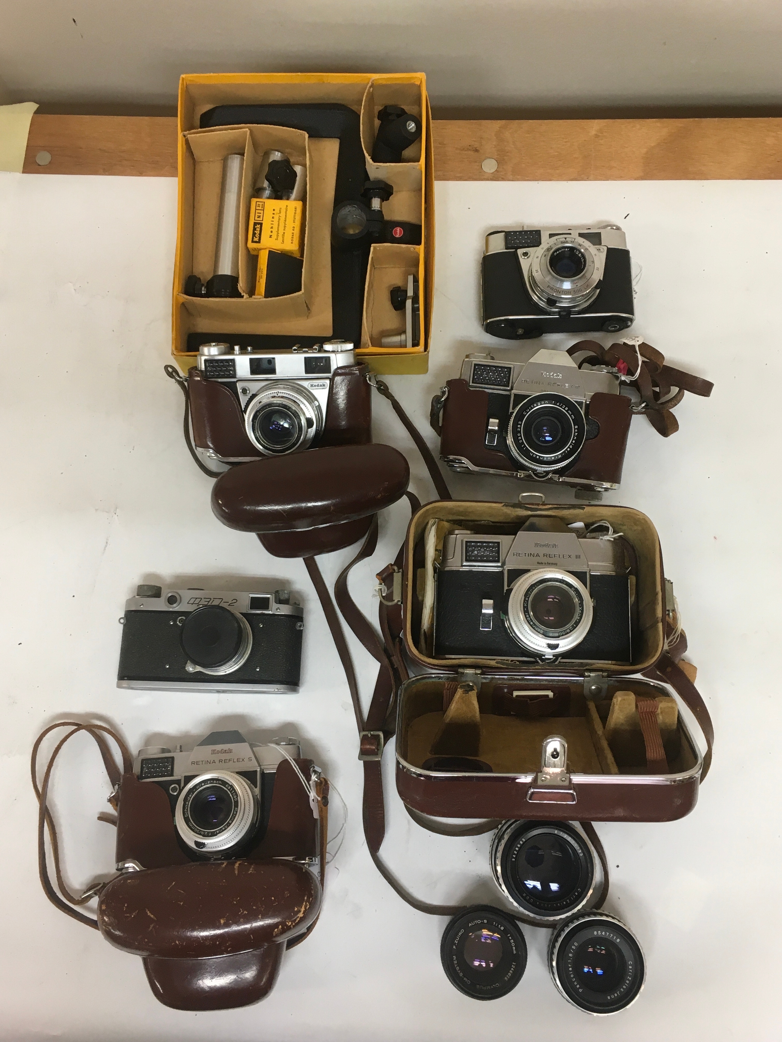 10 items. Camera holding equipment. 5, Kodak  Retina Reflex S, III, Prontor 500 LK. FED Soviet Era Russian Range finder camera.  Assortment of several camera lenses.