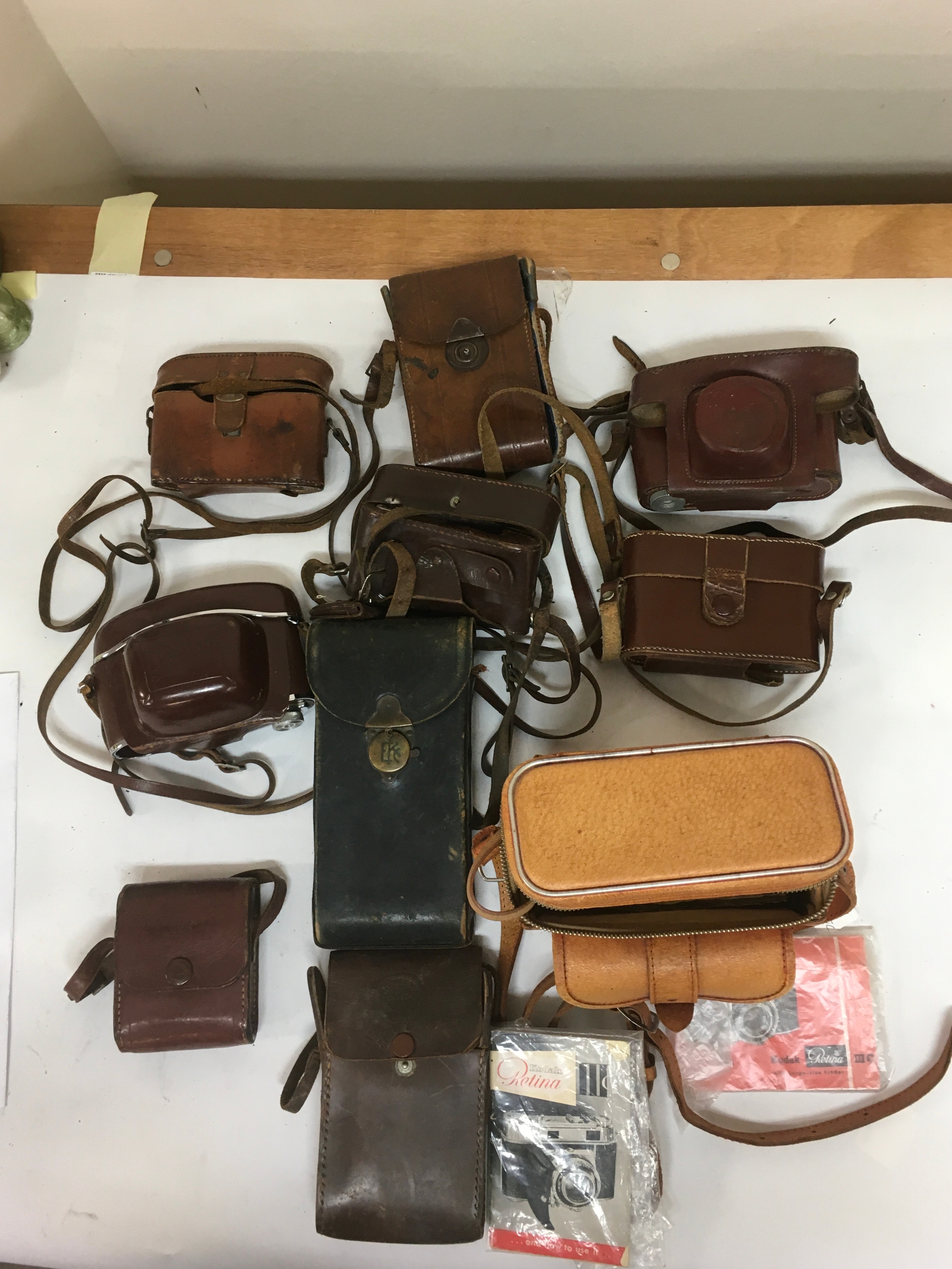 10  Camera holsters/ carriers for  period Kodak  and miscellaneous cameras. 1 includes information booklets on Kodak Retina Cameras. 