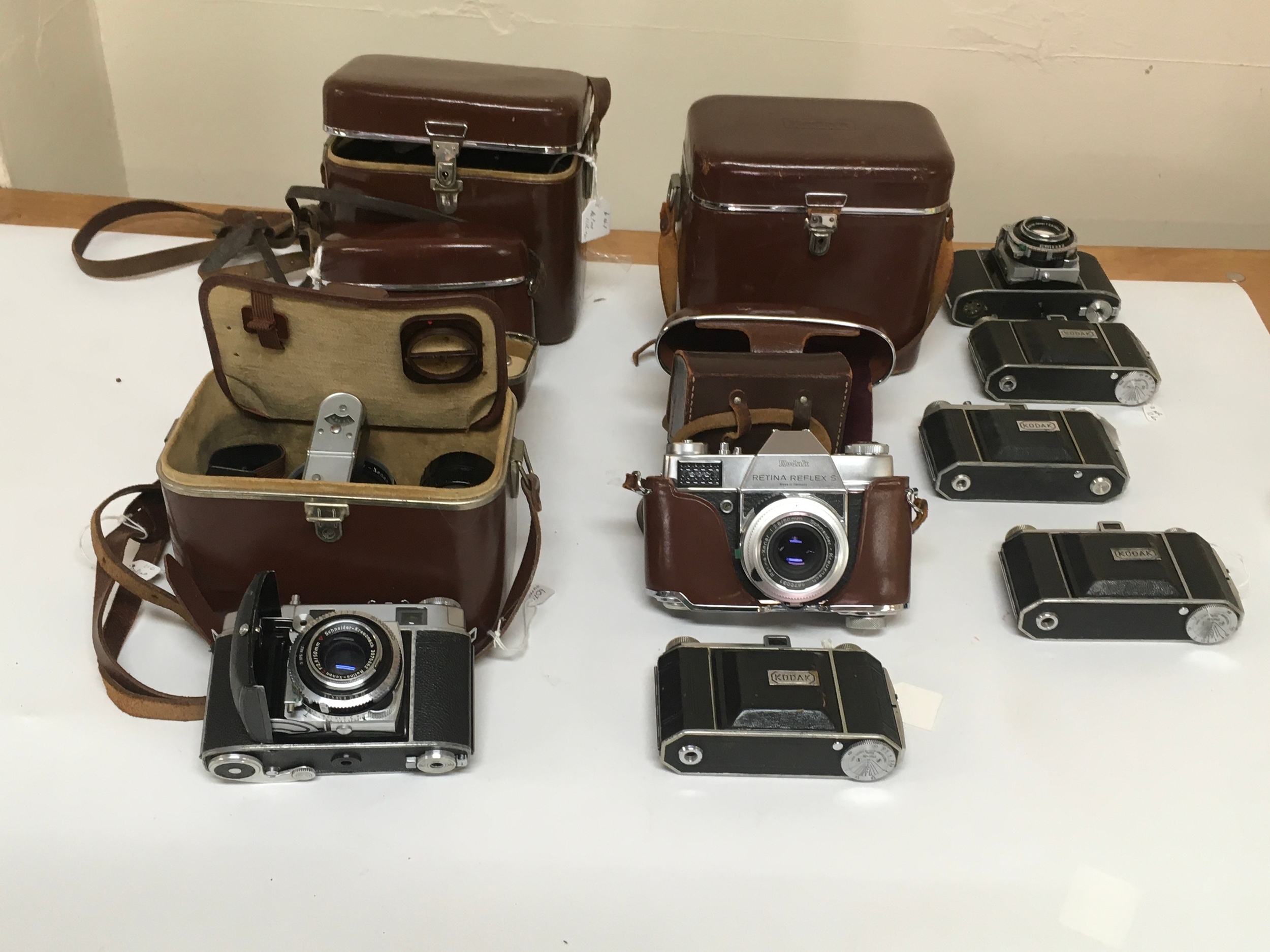 10 Kodak cameras. 1 Retina Reflex S with additional capabilities and holster. and 9 Kodak Synchro, 3 come with carrier Cases with additional lenses, range finders and manual.  
 