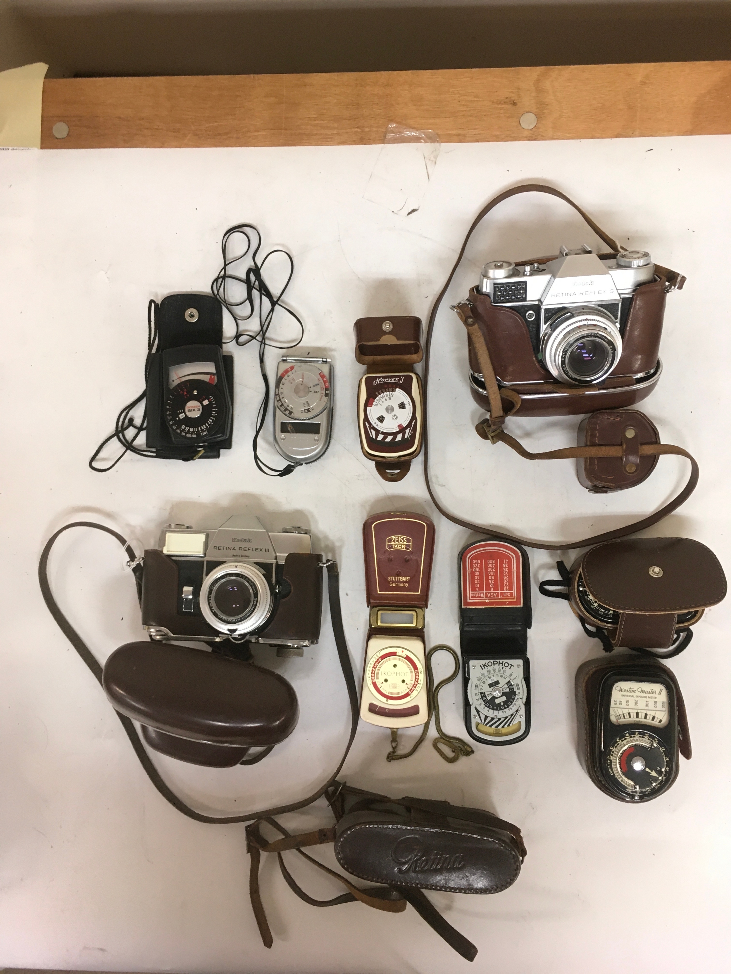 10 items. 2 Kodak Retina Reflex Cameras ( III & S 7), with holsters. 1 empty Retina holster for a Kodak Compur  camera. Exposure meters which include; 2 Weston masters II Universal Exposure Meter. 2  variations of  a Zeiss Ikon IKOPHOT. 1 Horvex 3. 1, Sekonda. 1 Gossen Bix 3 with bag. 
