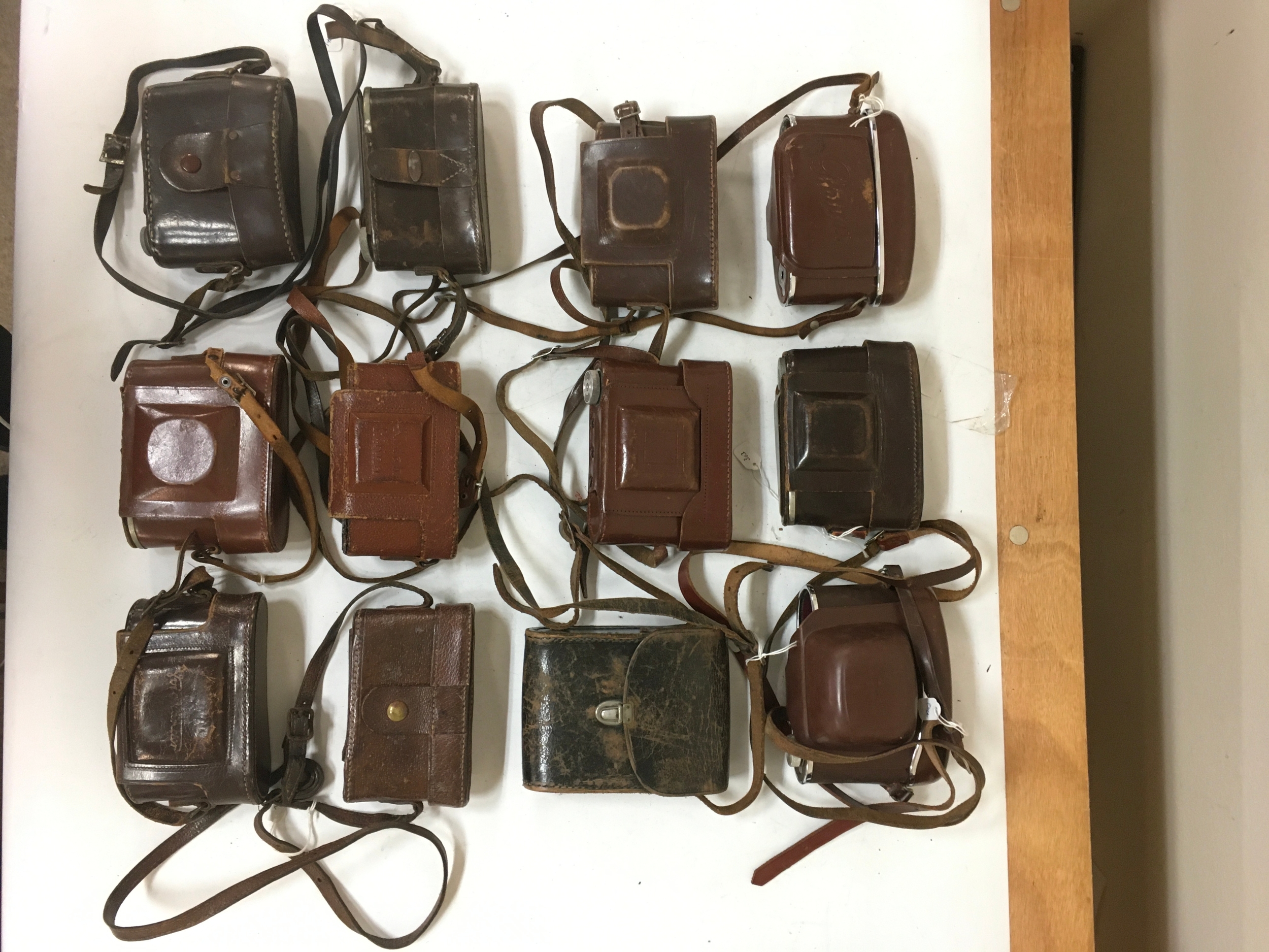 12 assorted empty camera cases/ holsters. Various Kodak Retina makes/ modals, and miscellaneous of other camera types.