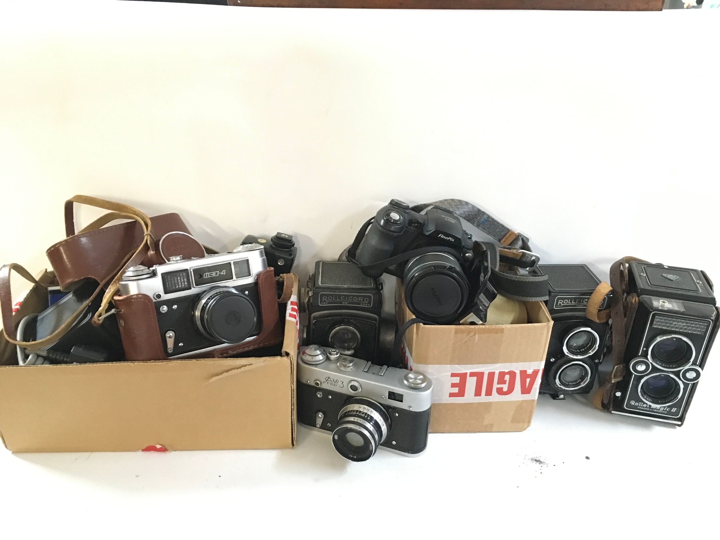 A collection of various cameras, Rolleicords, and different camera accessories. 
