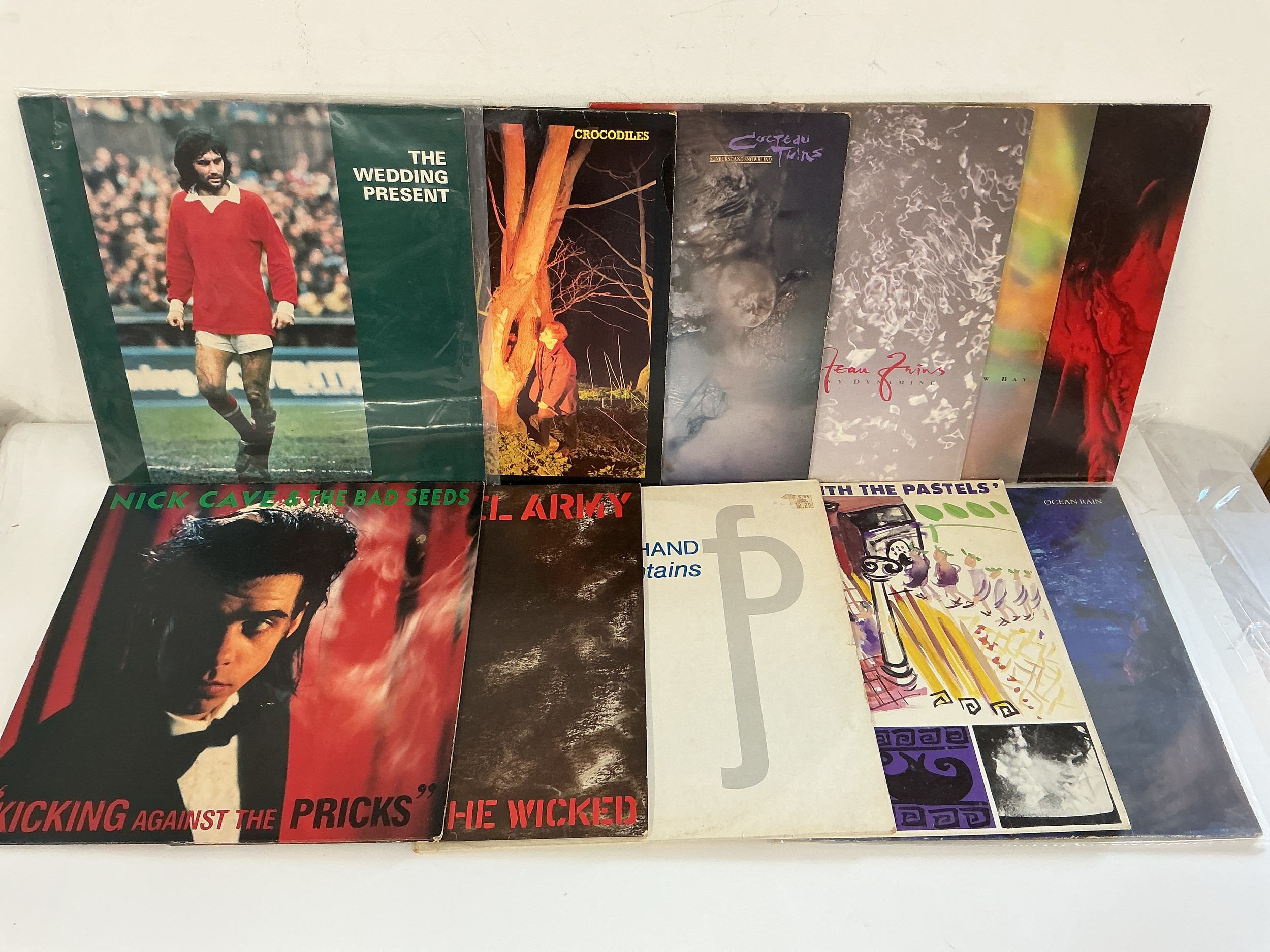 Two bags containing 21 LPs and 12" singles by various artists including Echo & The Bunnymen, Cocteau Twins, The Wedding Present and others.