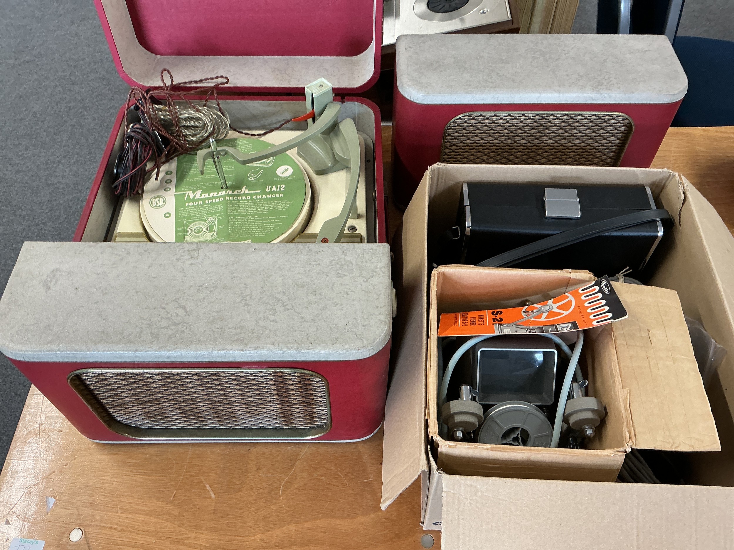 A vintage Monarch UA12 record player with an extra speaker plus other audio and visual equipment.