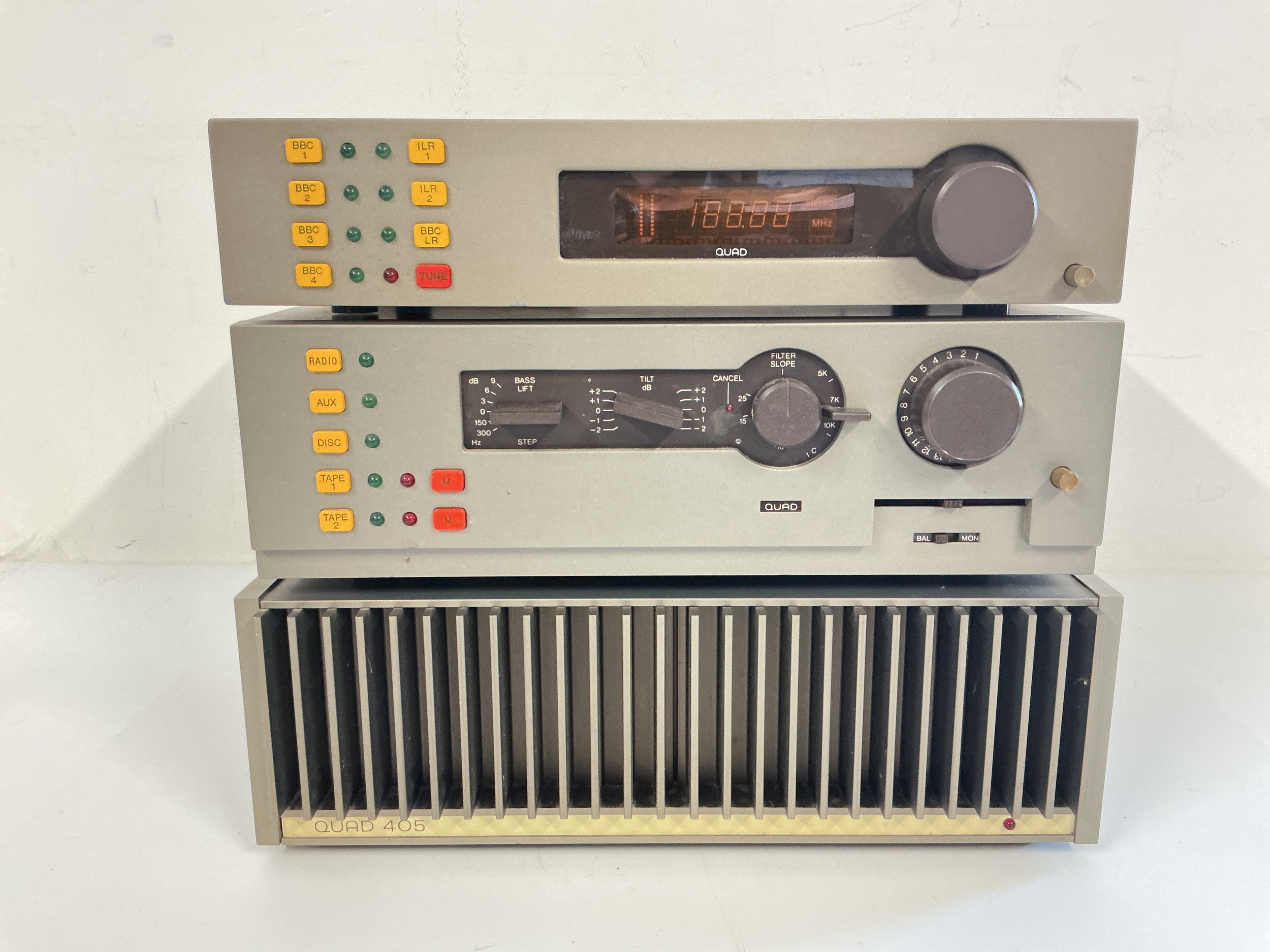 Three Quad separates comprising a boxed 405 power amp, a boxed 44 preamp control unit and an FM4 tuner (no box).
