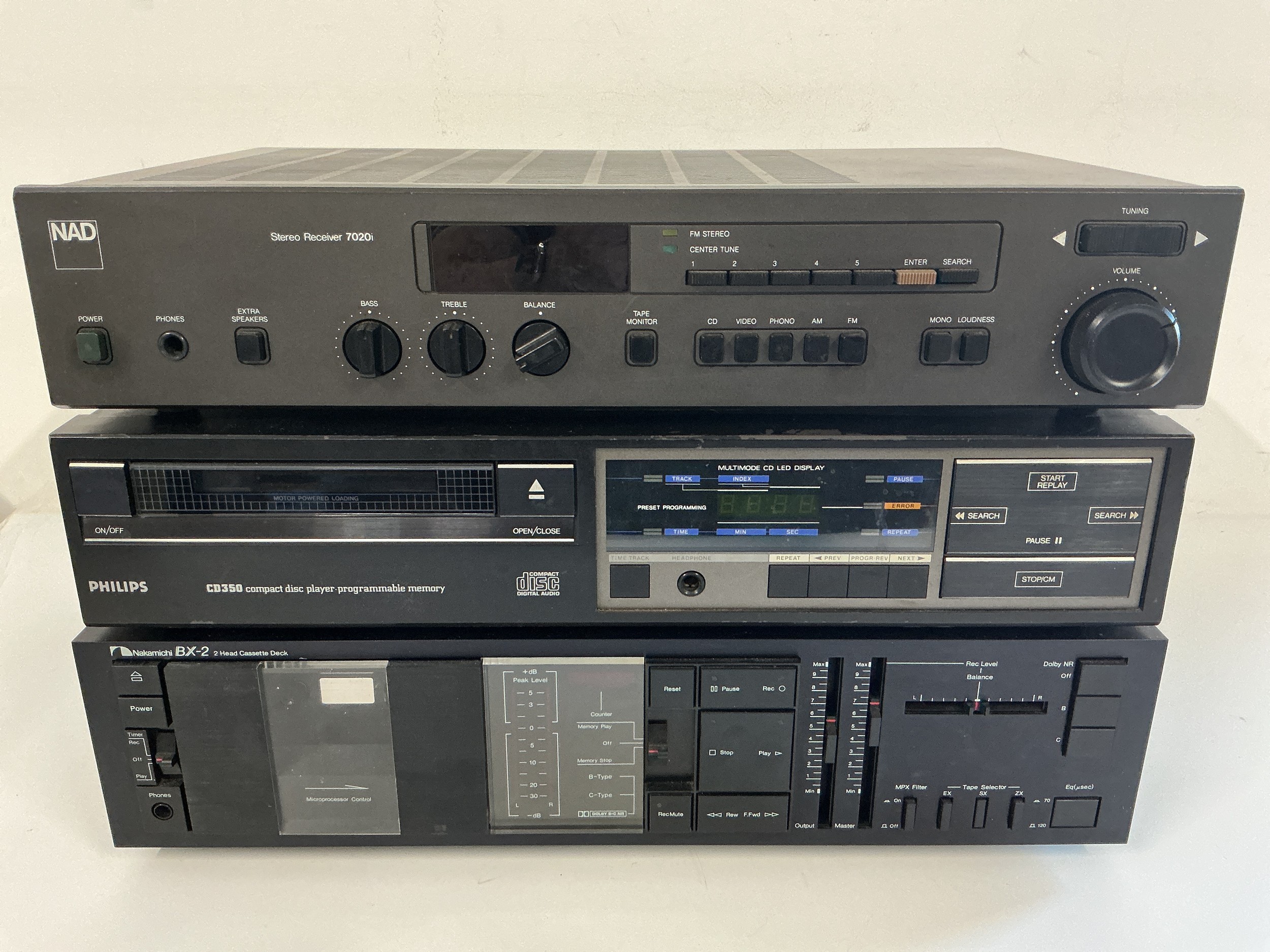 Three hifi separates comprising a NAD 7020i receiver, a Philips CD350 CD player and a Nakamichi BX-2 cassette deck.