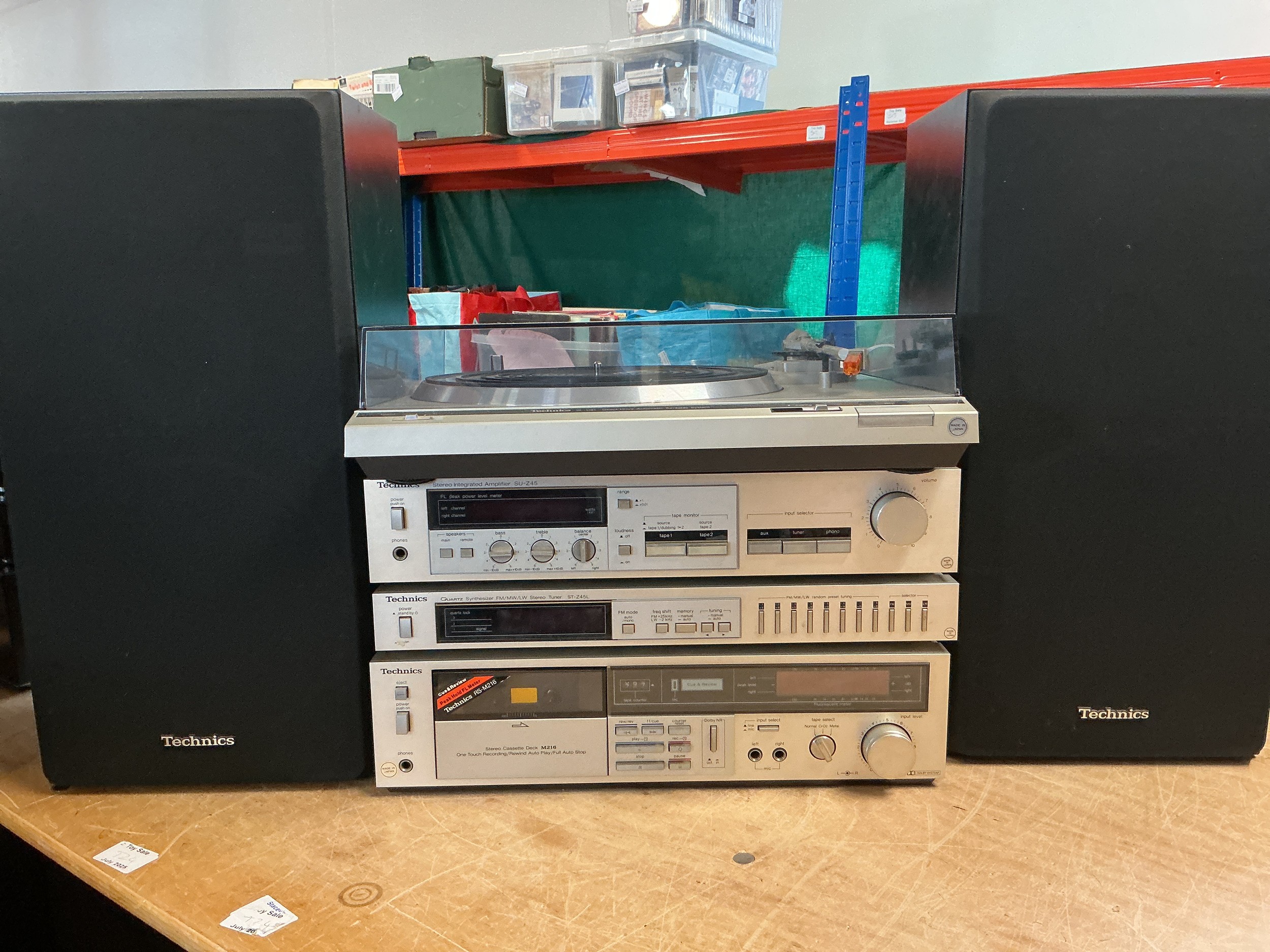 A boxed Technics stacking hifi system comprising an SL-D21 turntable, SU-Z45 amplifier, ST-Z45L tuner and M216 cassette deck plus a pair of Technics SB 3130 speakers.