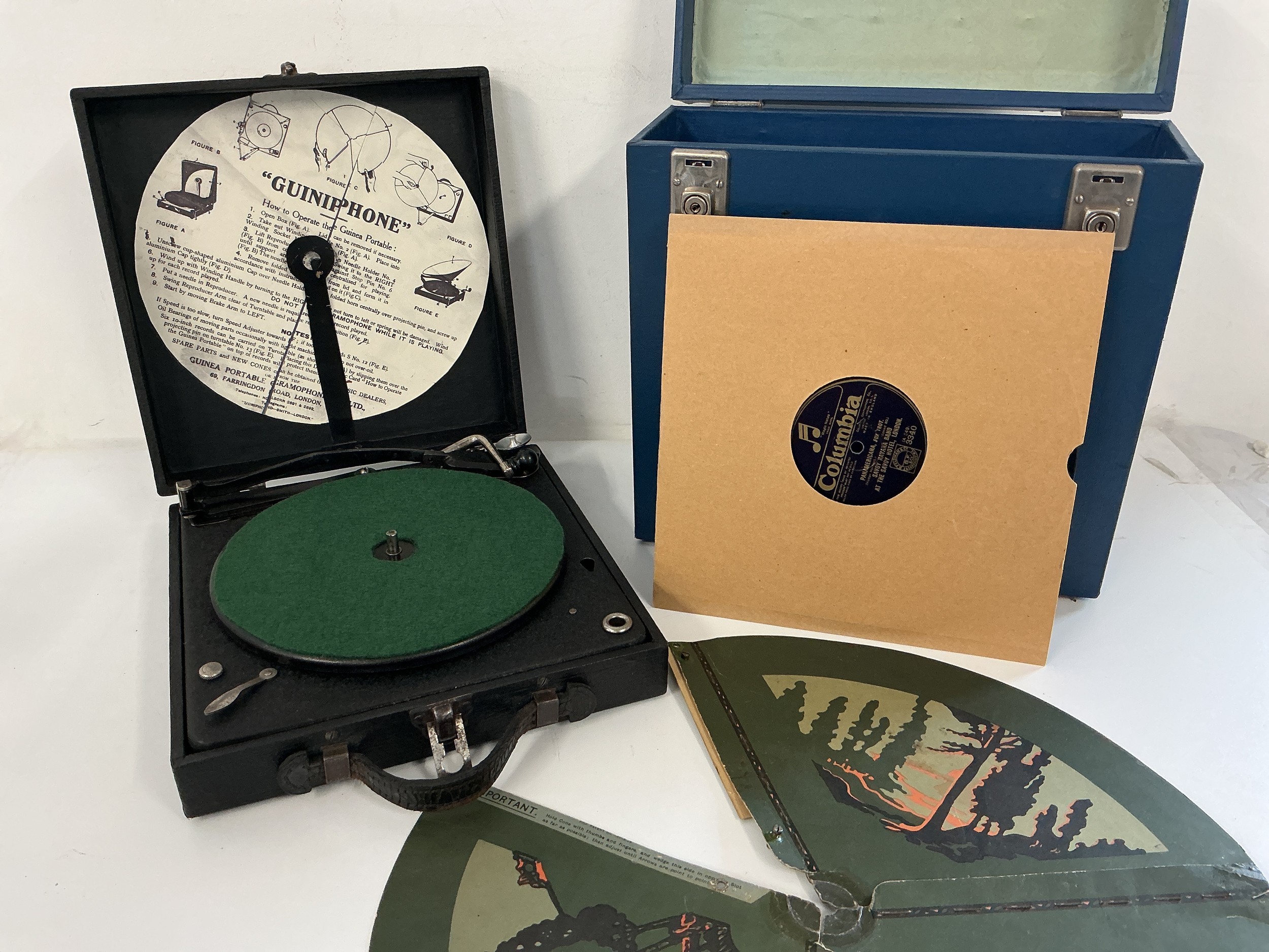 A Guinea 'Guiniphone' portable gramophone with original cardboard landscape cone and a record case of 78s (2).