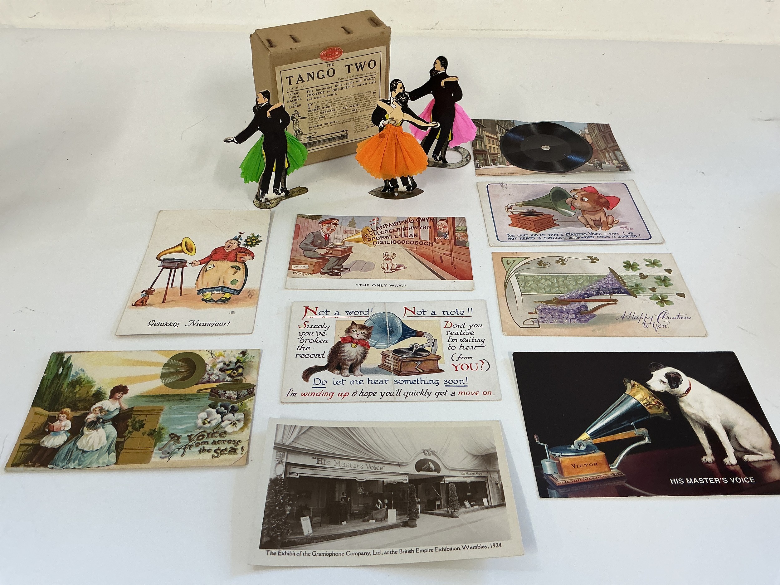 A collection of gramophone accessories including a boxed Tango Two mechanical dancing toy, needles, tins, postcards etc.