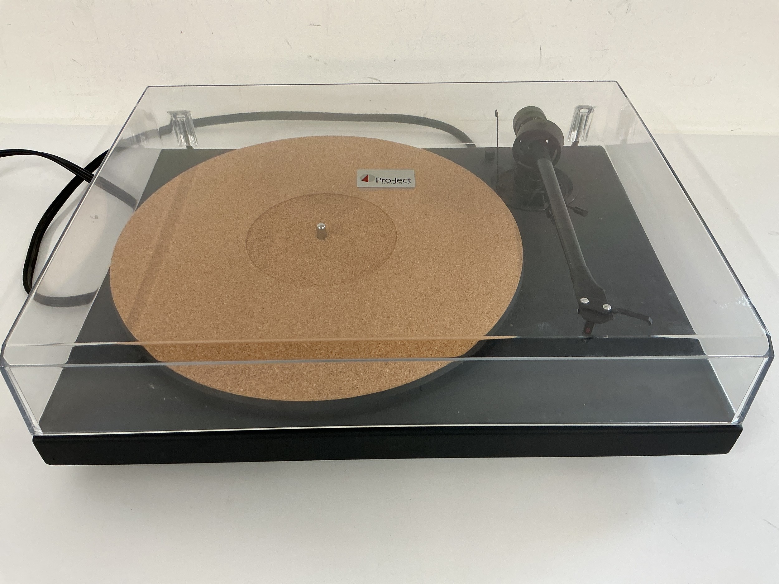 A boxed Pro-Ject 1 Expression turntable fitted with an Ortofon OMB20 red stylus. Comes with power lead, manual and a spare Ortofon 20 red stylus.