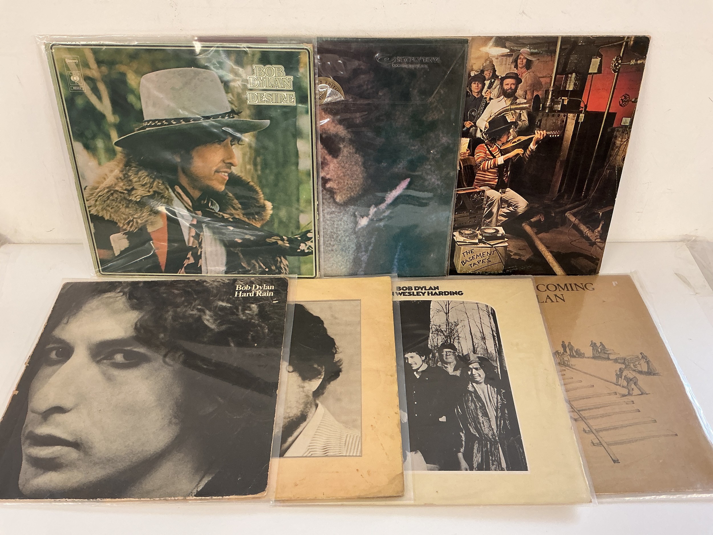 Two bags containing thirteen Bob Dylan LPs comprising Blood On The Tracks, Desire and others plus a Bootleg Series 3CD box set.