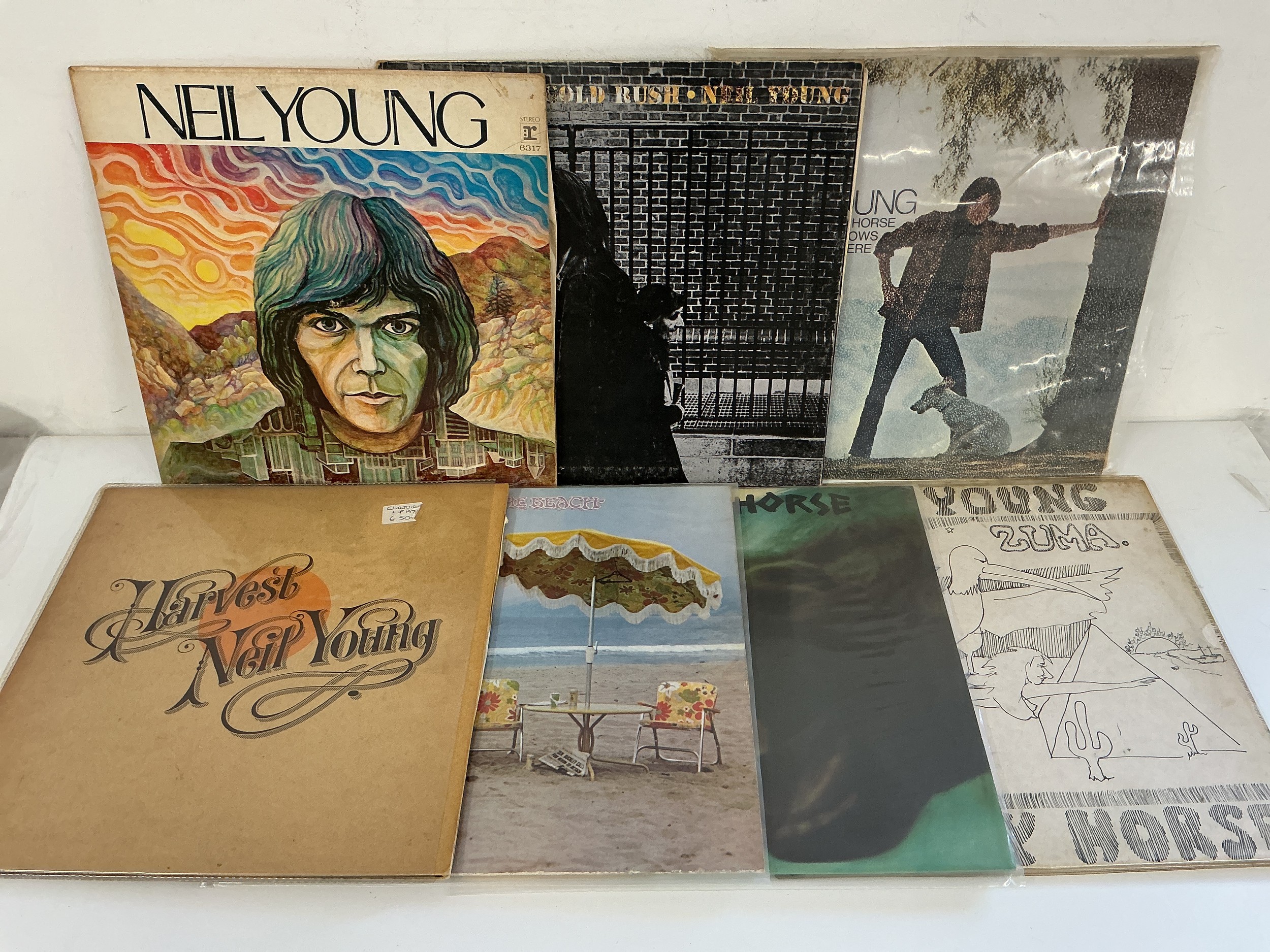 Two bags containing fourteen Neil Young and related LPs comprising After The Gold Rush, On The Beach, Time Fades Away and others.