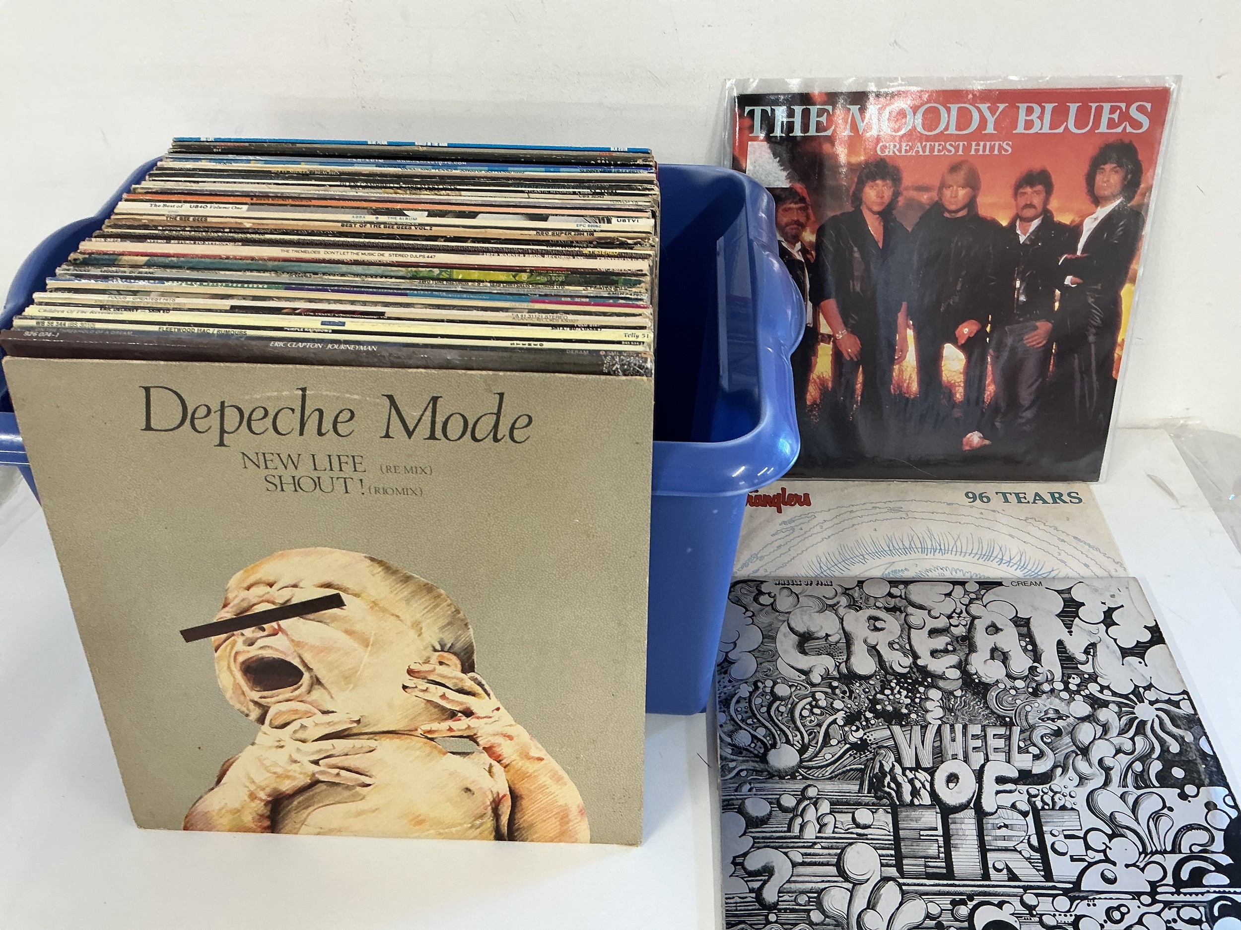 A box of LPs and 12" singles by various artists including Cream, Stephen Stills, Depeche Mode and others.