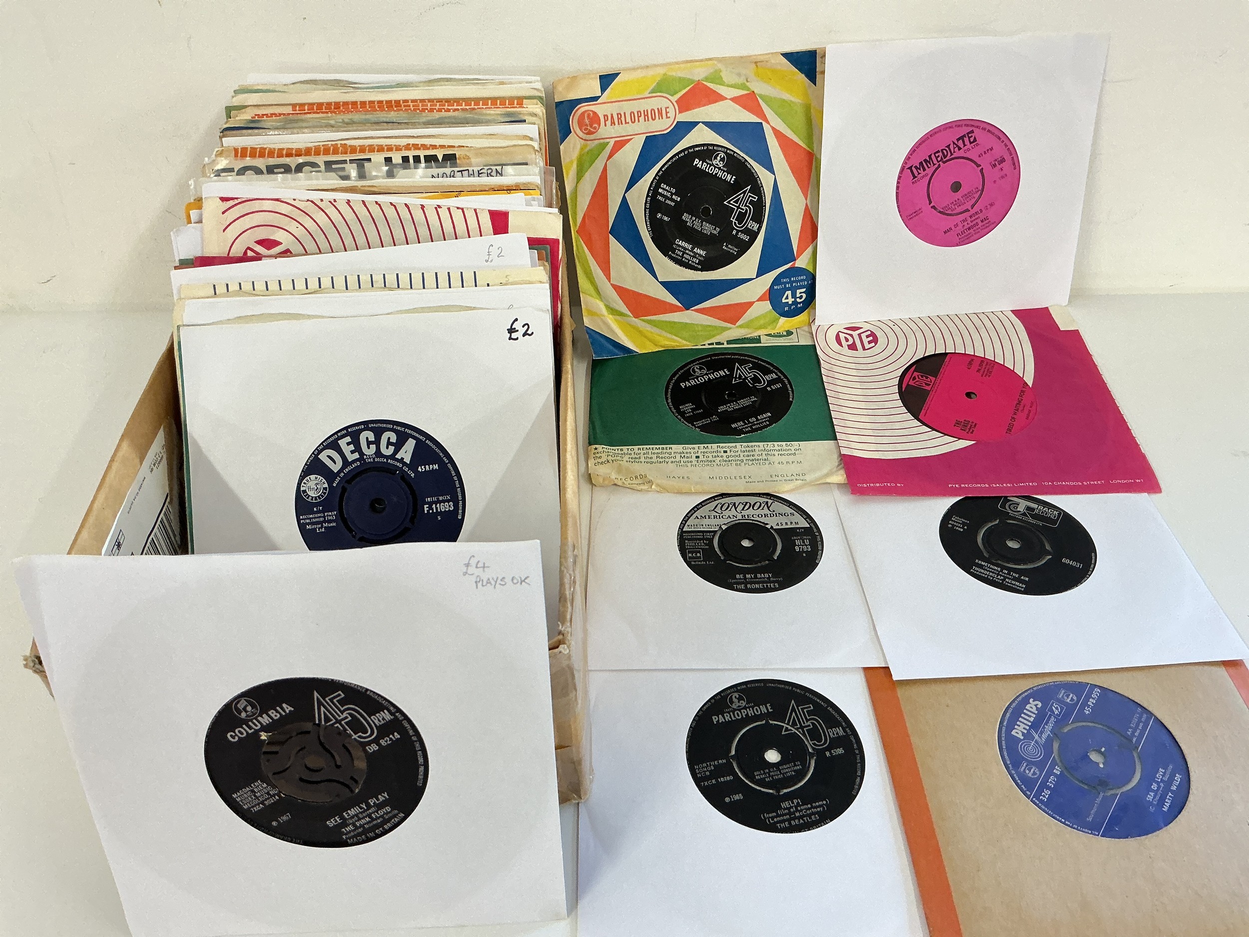 A box of 1960s 7" singles and EPs by various artists including Pink Floyd, The Beatles, Rolling Stones and others.