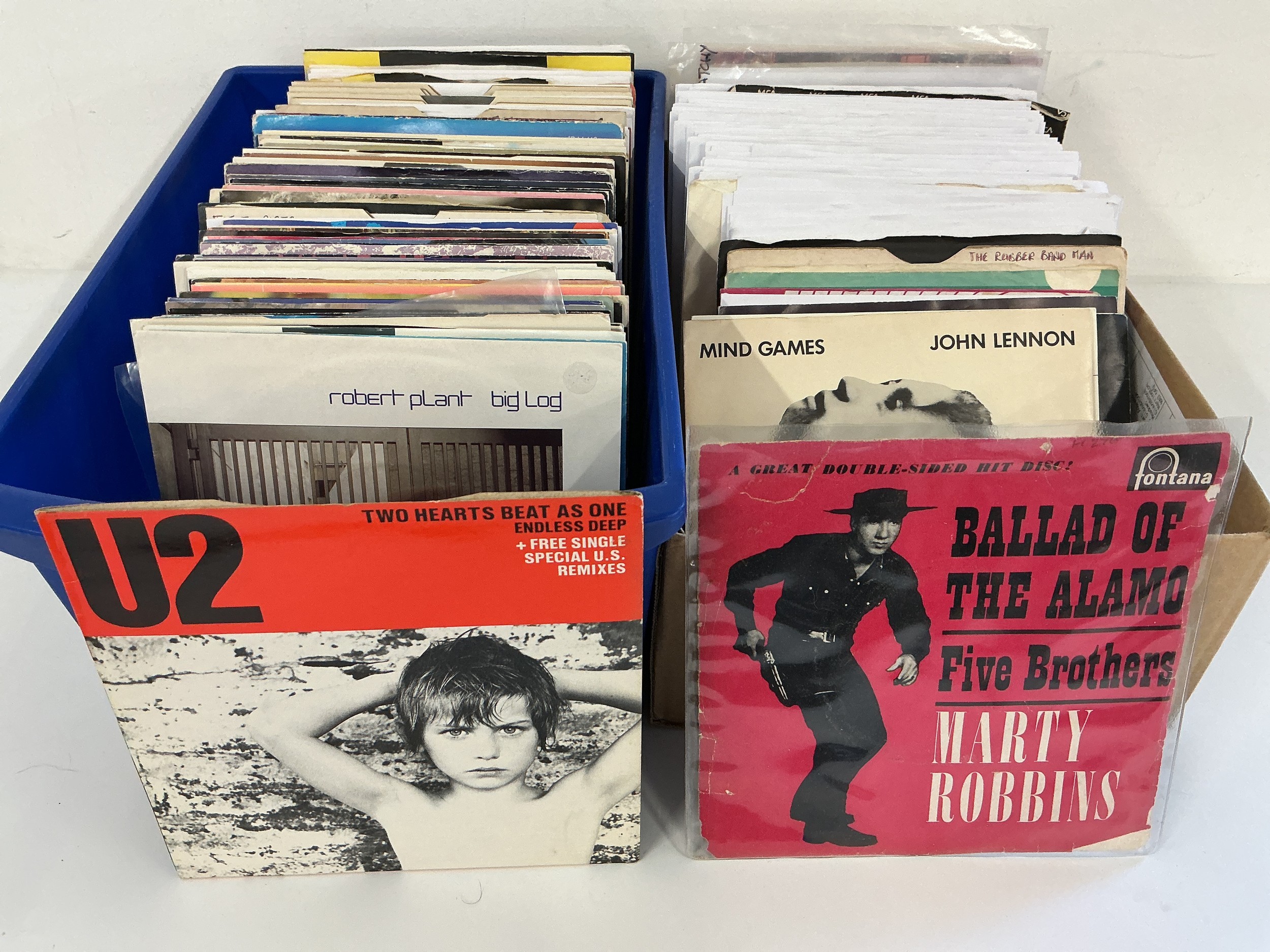 Two small boxes of 7" singles by various artists from the 1960s onwards.