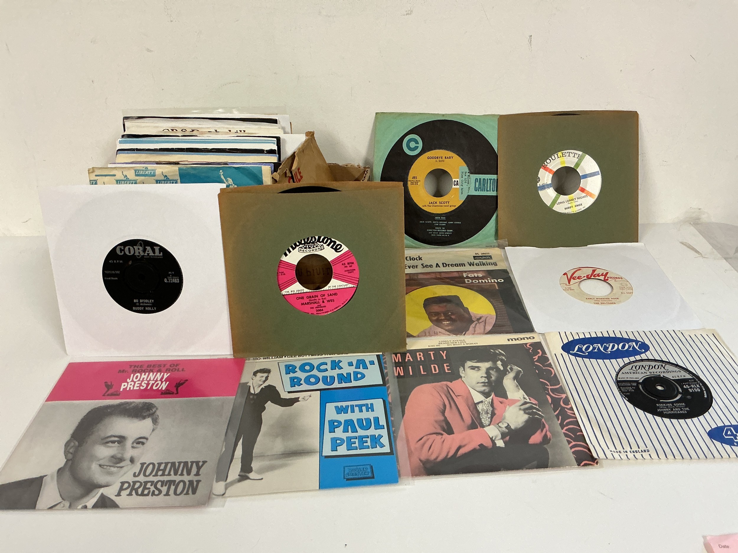 A collection of approx 50 rock n roll and rockabilly 7" singles and EPs by various artists including Marty Wilde, Elvis Presley, Buddy Holly and others.