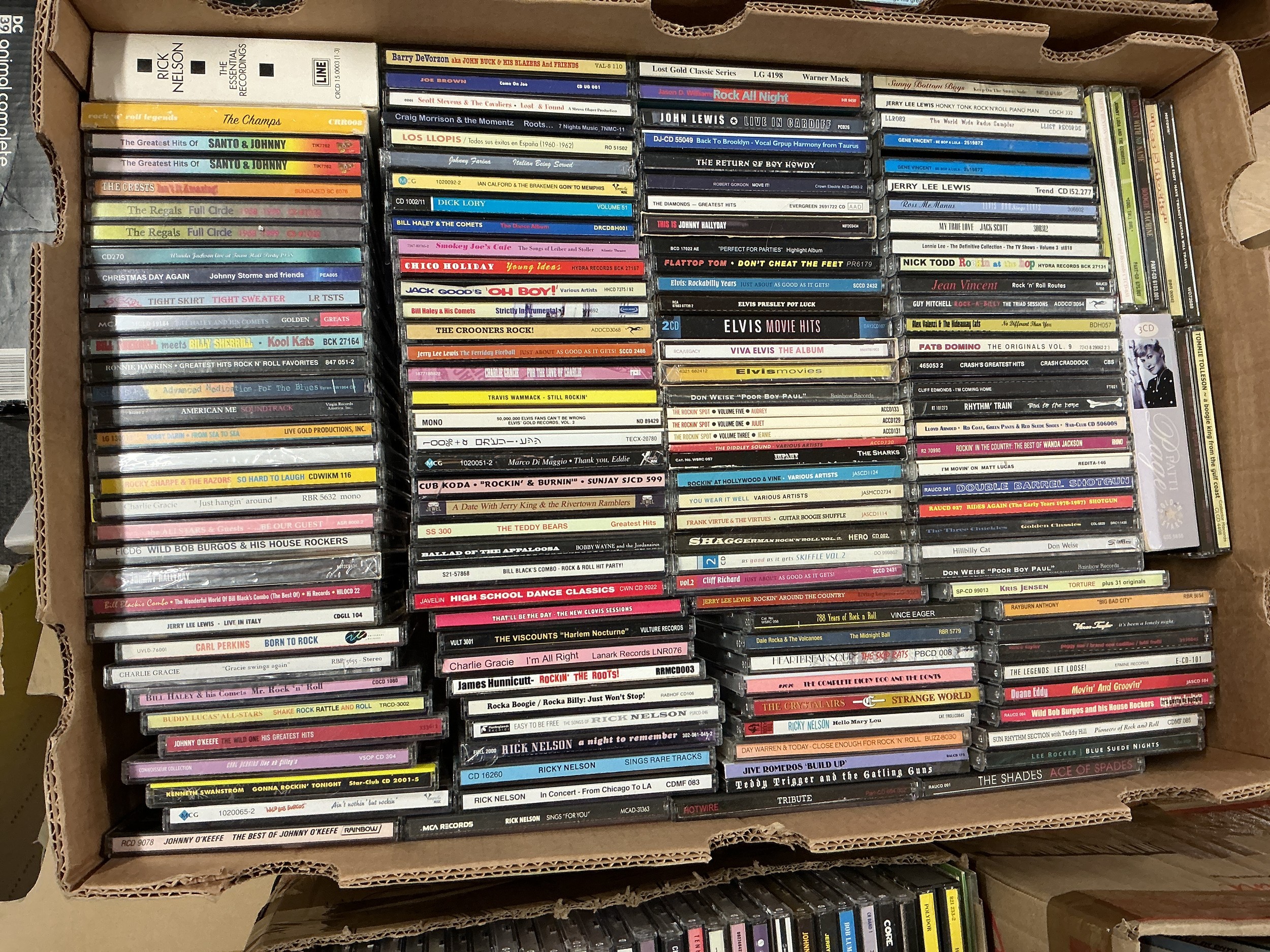 Two boxes of rock n roll and rockabilly CDs and cassettes by various artists including Elvis Presley, Jerry Lee Lewis, Tommy Steele and others.