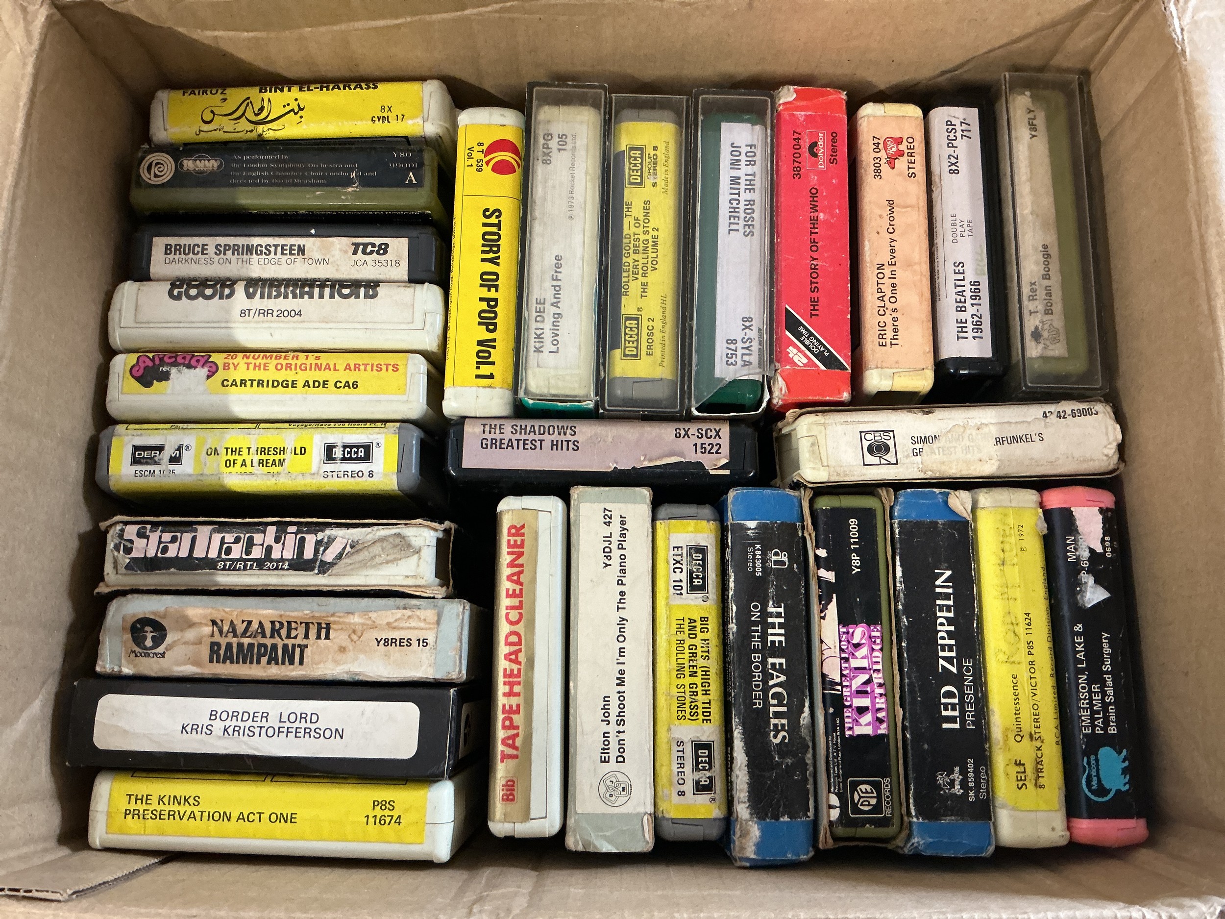 A collection of 8 track cassettes by various artists including Led Zeppelin, The Beatles, Nazareth and others.